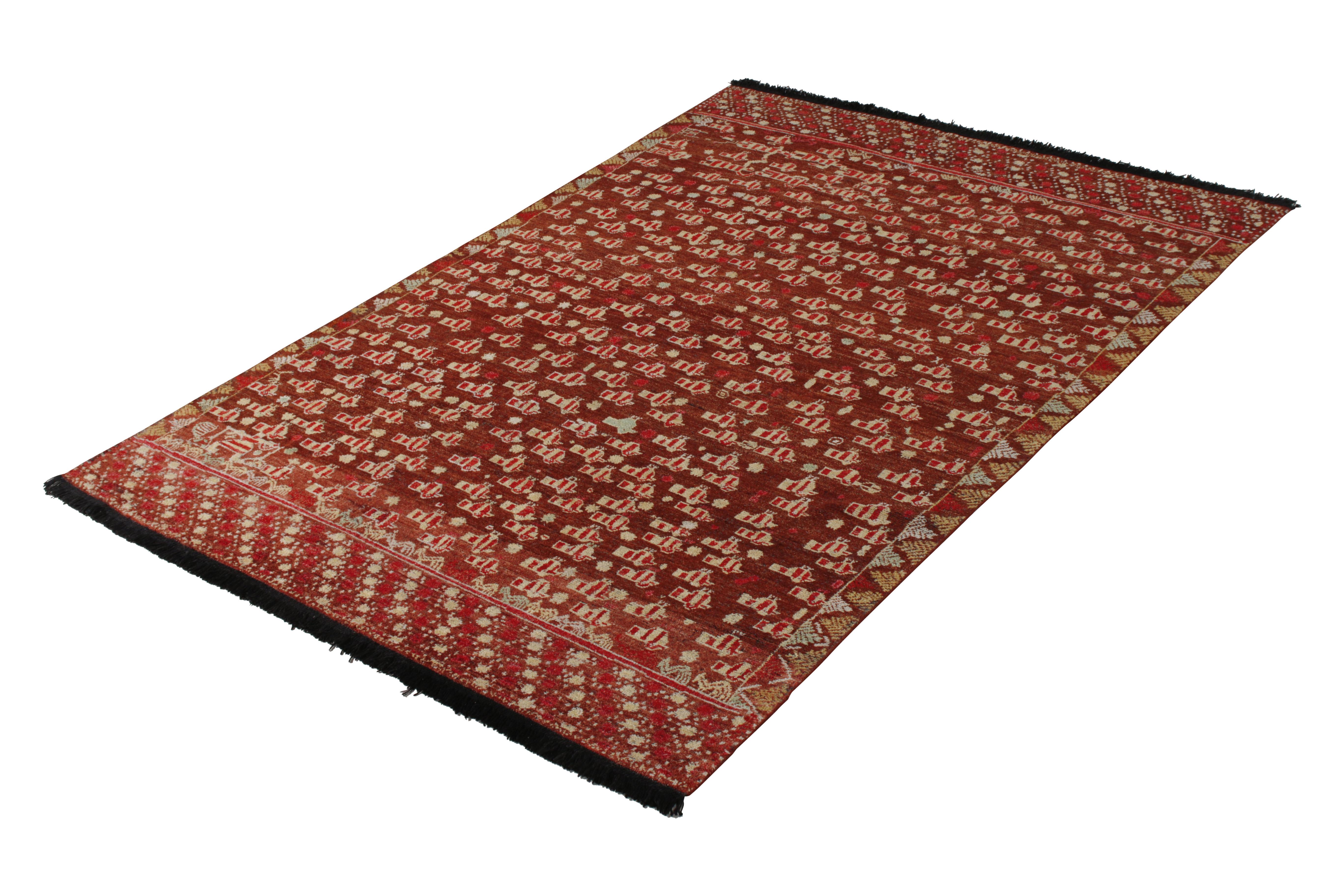A 6x9 rug from the Burano Collection by Rug & Kilim, recapturing classic inspirations like that of this Ersari rug style pattern; hand-knotted in notably soft Ghazni wool and a proprietary blend of yarns in a rich play of red on brown in this tribal