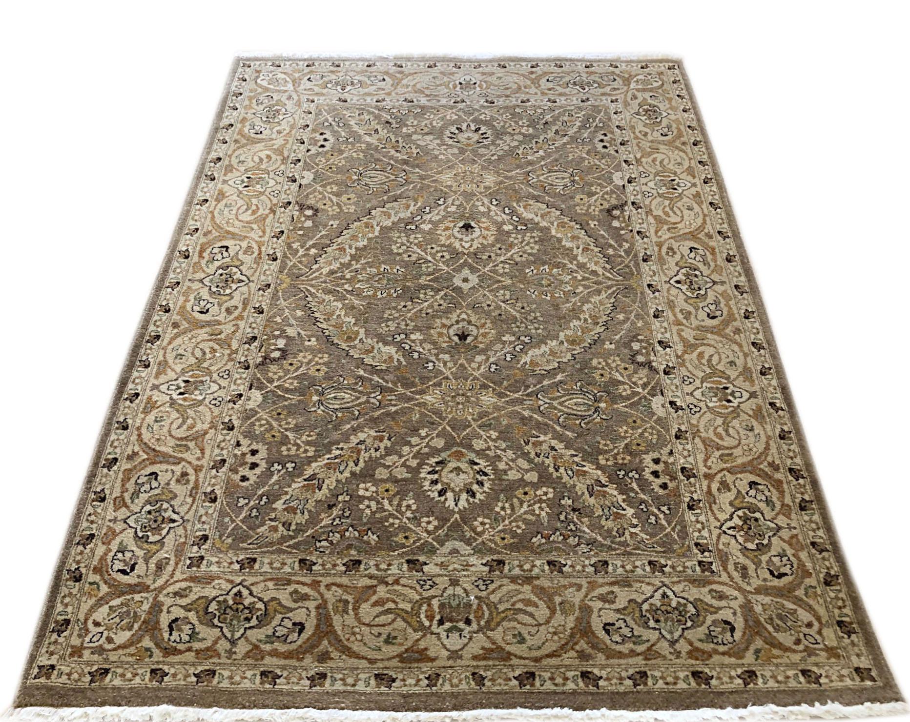 21st century hand knotted Pakistan rug with wool pile and cotton foundation. This piece has a floral pattern and the base color is light olive with cream border.
 