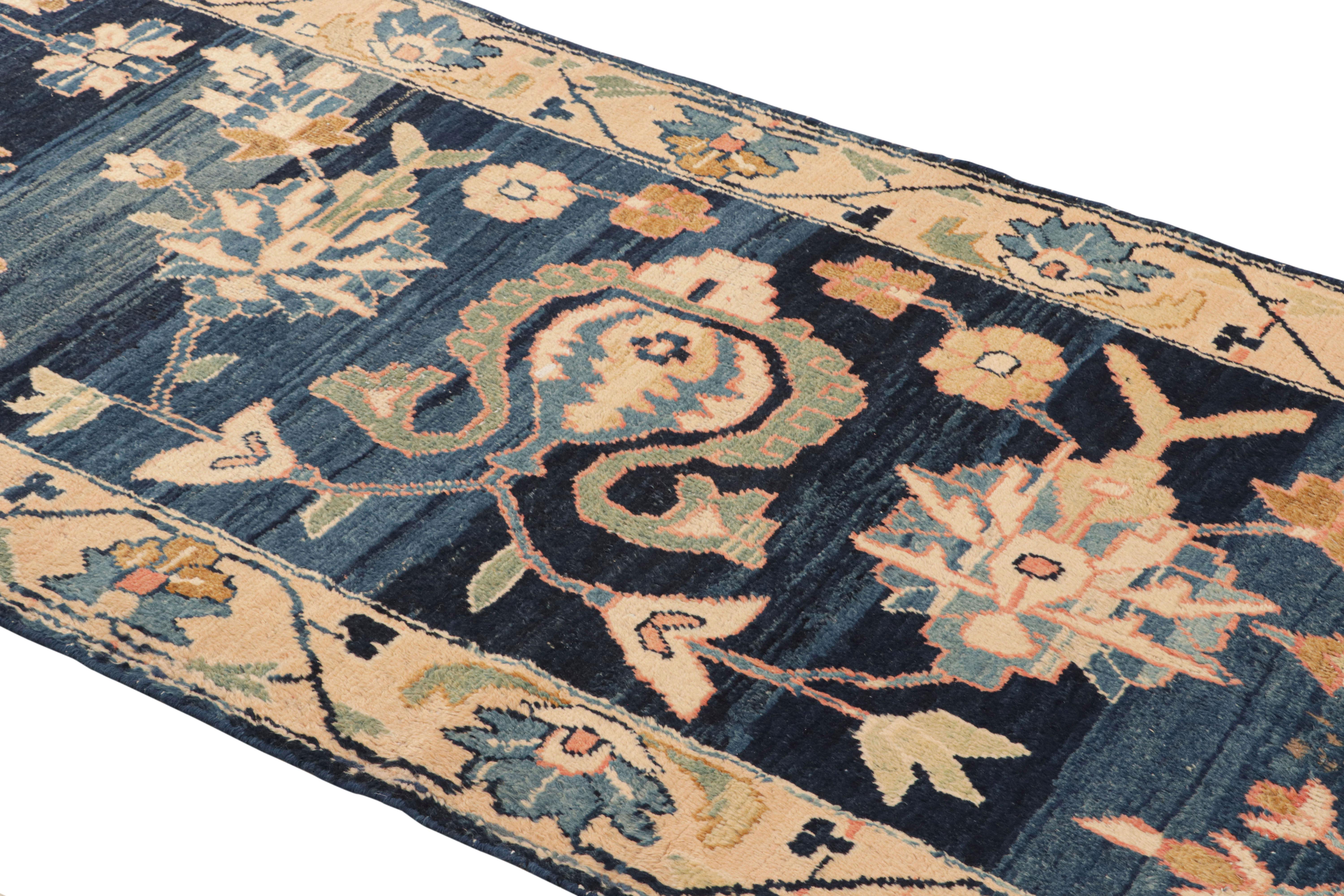 This vintage midcentury Persian rug, circa 1950-1960 measures 3’5 x 13’8 and features a Mahal rug design of collectible renown. As with most Mahal designs, this runner has a coarse weave, handmade in wool with striking blue and yellow complemented