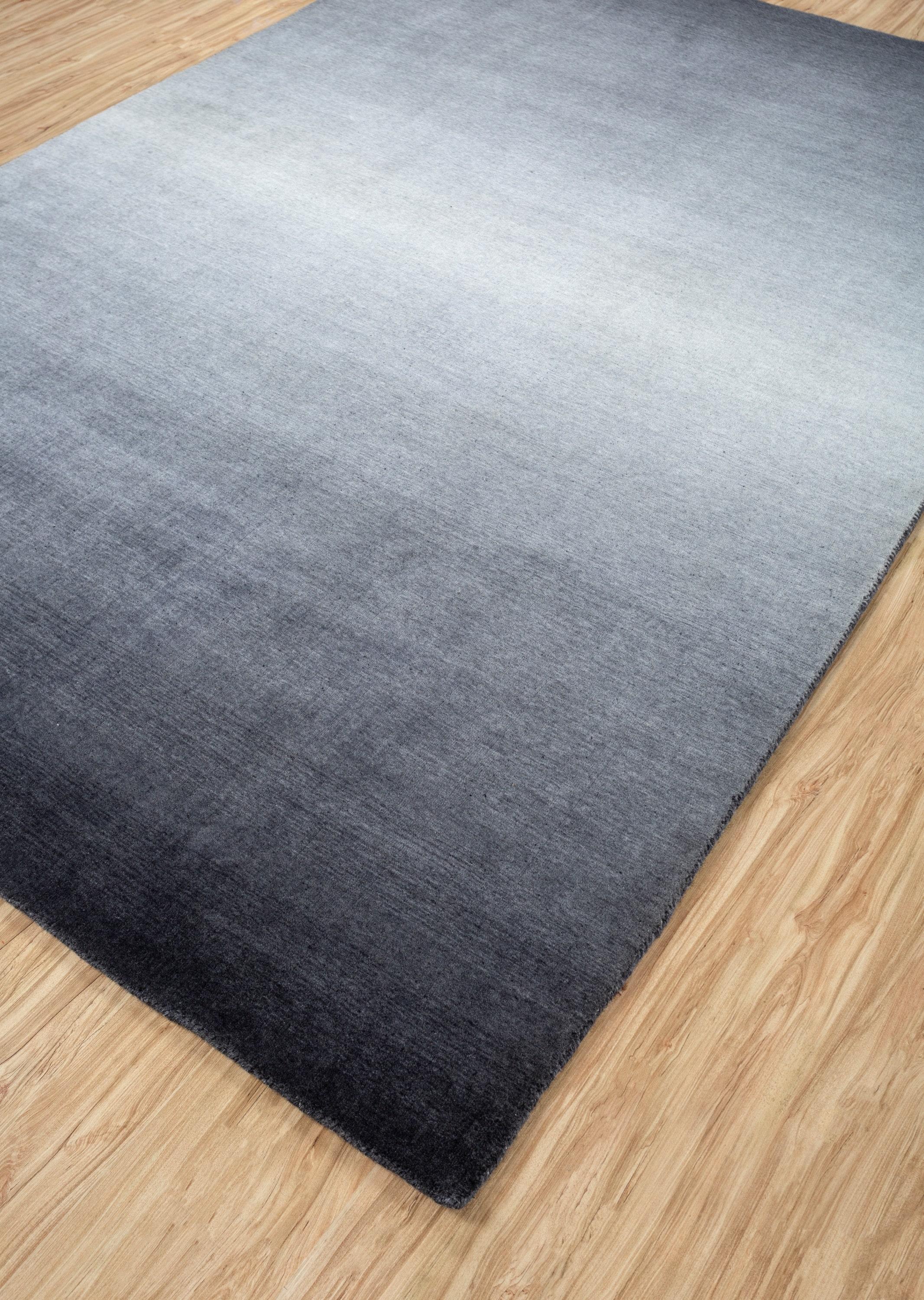 Ce tapis en laine Jaipur noué à la main de 9' x 12' en ébène profond et ardoise anthracite dégage une élégance moderne et discrète. Fabriqué par des artisans qualifiés, le motif texturé subtil du tapis ajoute de la profondeur aux intérieurs