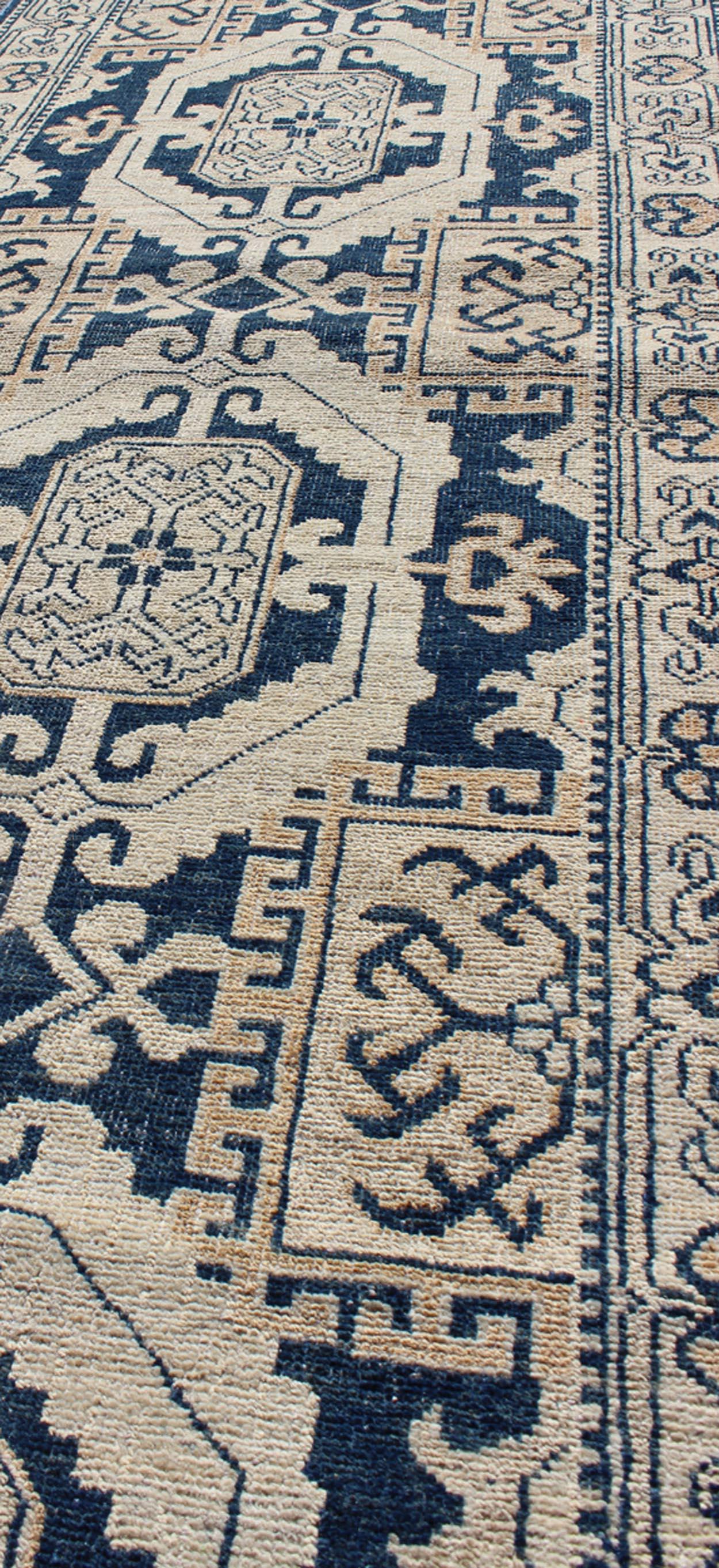 Contemporary Hand Knotted Khotan Runner with Geometric Medallions in Navy and Cream Tones For Sale