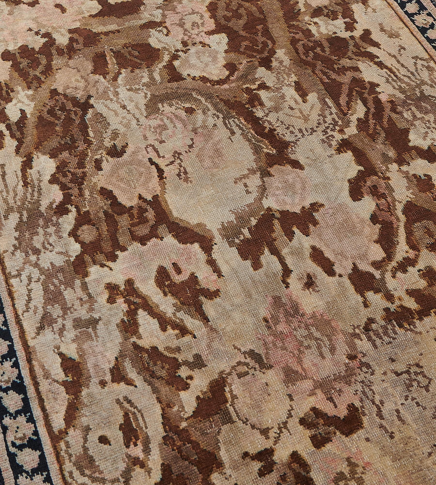 This late 19th century Karabagh runner features an overall design of chocolate-brown, dusty-pink, mole-brown and ivory bold floral sprays linked by scrolling and meandering floral vine, in a narrow charcoal-blue border of meandering floral vine