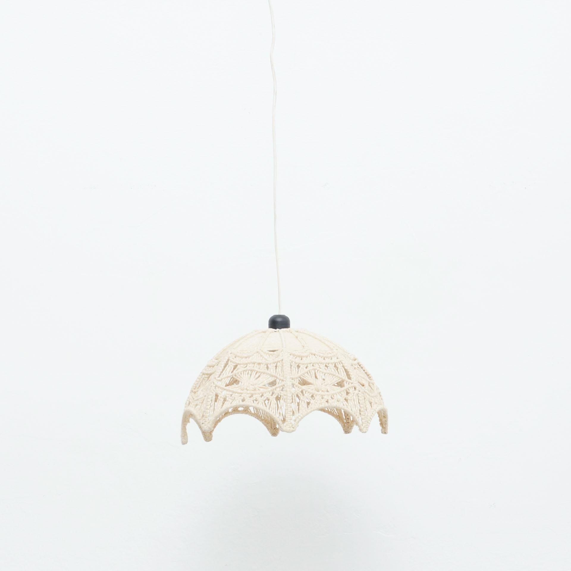 Hand knotted macramé ceiling lamp by unknown manufacturer, circa 1960.

In original condition, with minor wear consistent with age and use, preserving a beautiful patina.

Materials:
Textile
Metal

Dimensions:
Ø 37 cm x H 22