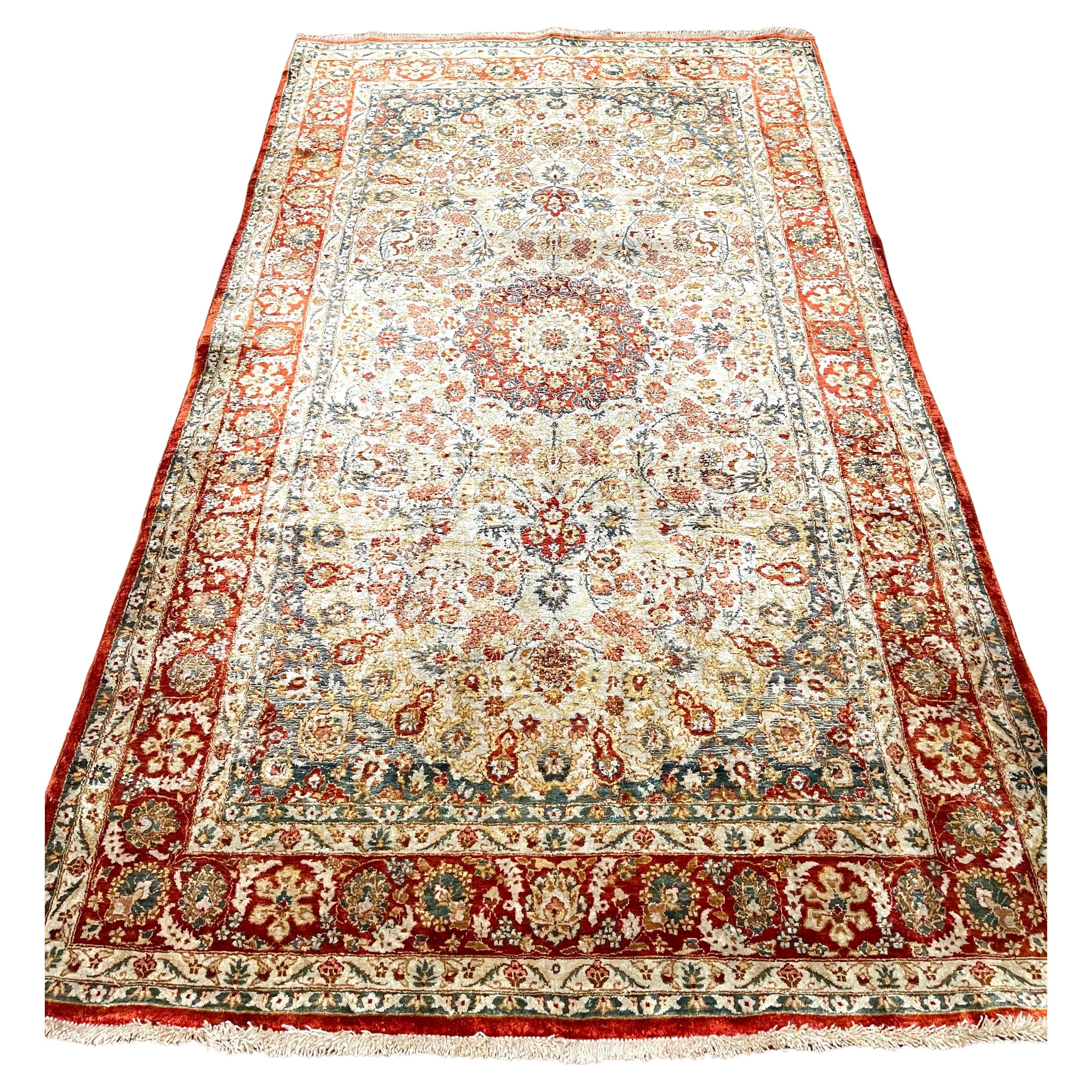This hand-knotted Chinese runner rug features a silk pile and cotton foundation. The rug's base color is cream and border is red, which adds a touch of elegance and versatility to its overall aesthetic. The design in this beautiful piece is