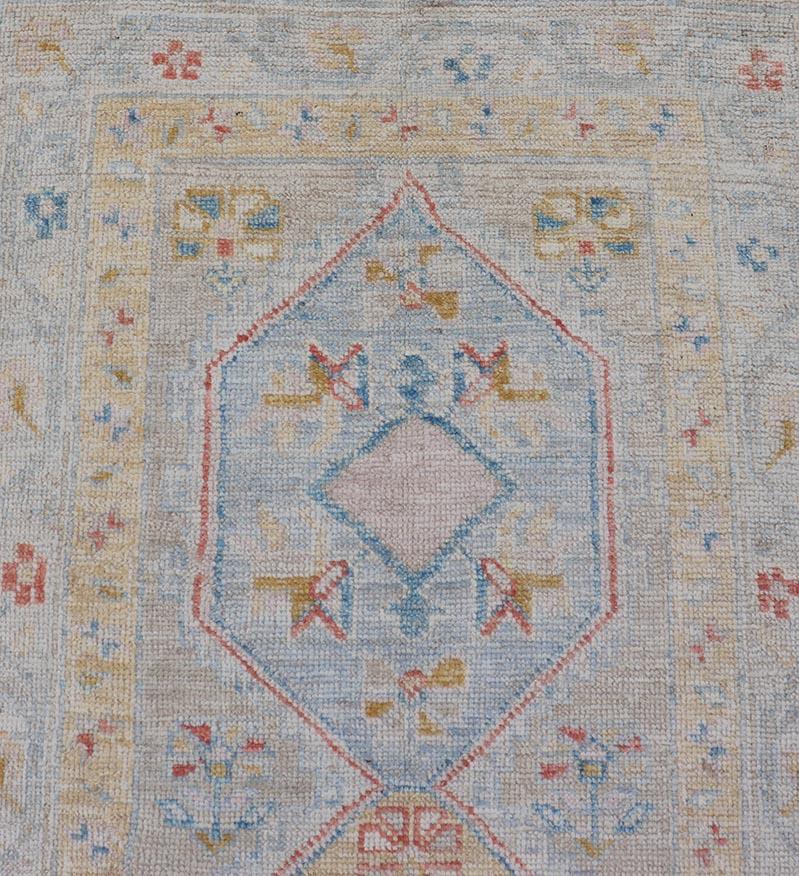 This piece showcases brilliant medallions encasing motifs in buttery yellow, light blue, cream, and shades of blue. The border displays a yellow guard border with a cream border. 

Measures; 2'6 x 7'11 

Keivan Woven Arts; rug AWR-6117 Country
