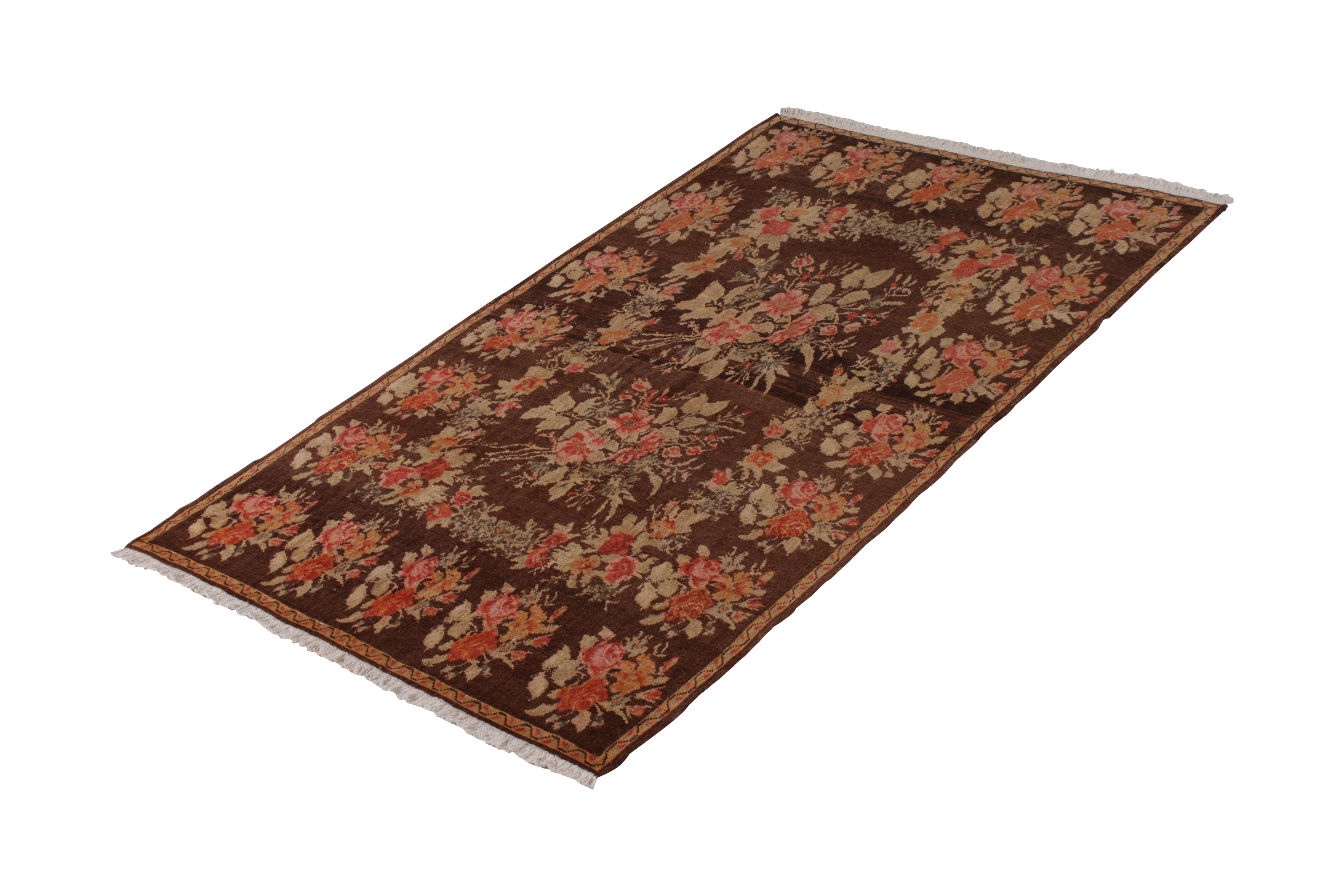 Hand knotted in wool pile originating from Turkey circa 1950-1960, this vintage rug connotes a midcentury Bessarabian rug design in the inspiration, likely remarking a nomadic influence in the piece signifying immediate European take on these
