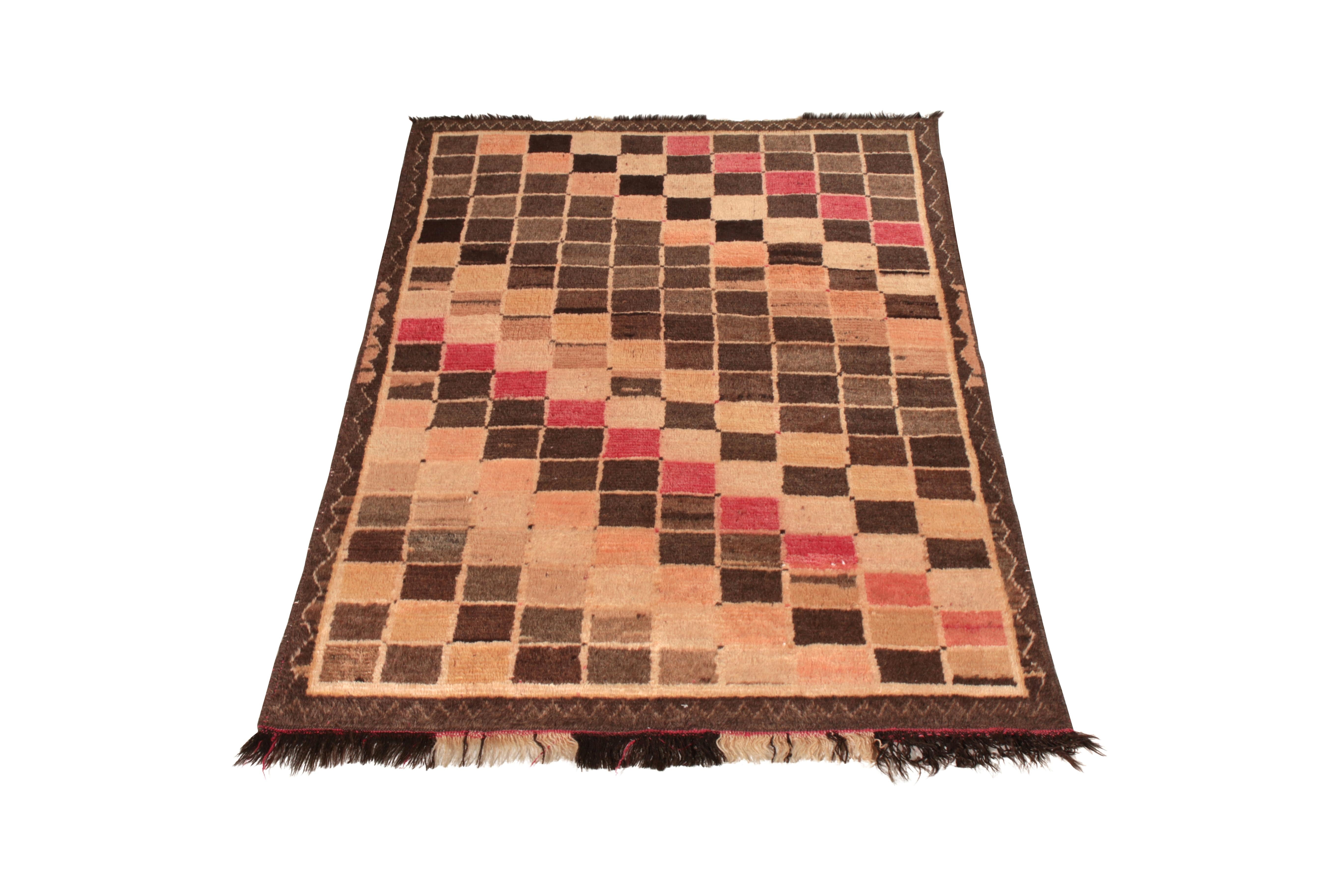 Hand knotted in wool originating circa 1950-1960, this midcentury Persian rug connotes a vintage Gabbeh rug design of exceptional Mid-Century Modern sensibility, offering the Classic beige-brown pallet this family is known for pairing with its lush