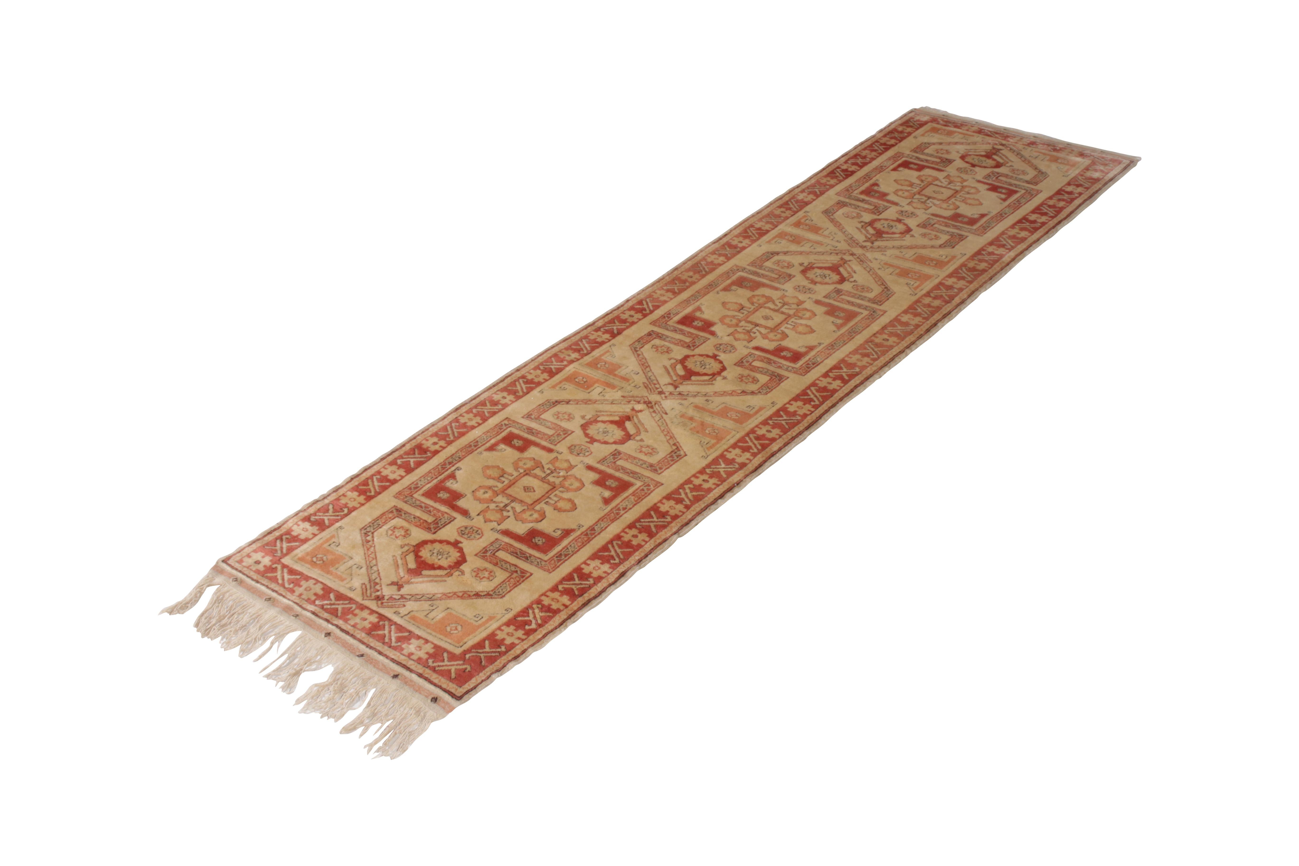 Hand knotted in wool originating from Turkey circa 1950-1960, this vintage runner connotes a midcentury Kazak rug design, one of the most celebrated families of Turkish and Oriental rugs seldom seen in this spacious 3 x 11 runner length so suited to