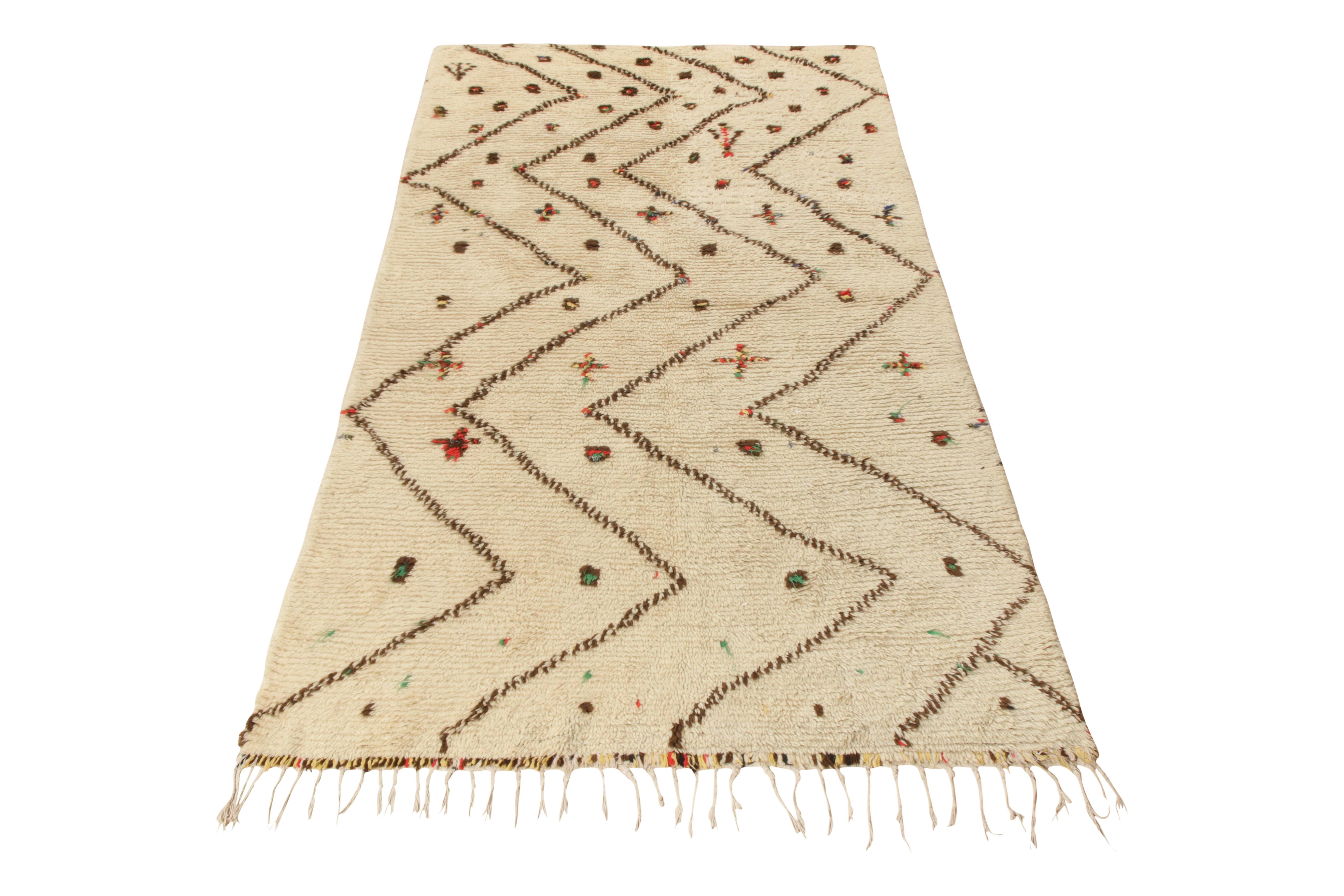 Hand knotted in wool and hailing from Morocco circa 1950-1960, this 5x10 vintage Moroccan rug of Berber provenance enjoys both a rare color and exceptional quality for its period.

On the Design: 

Hues of beige with cream white tones underscore a