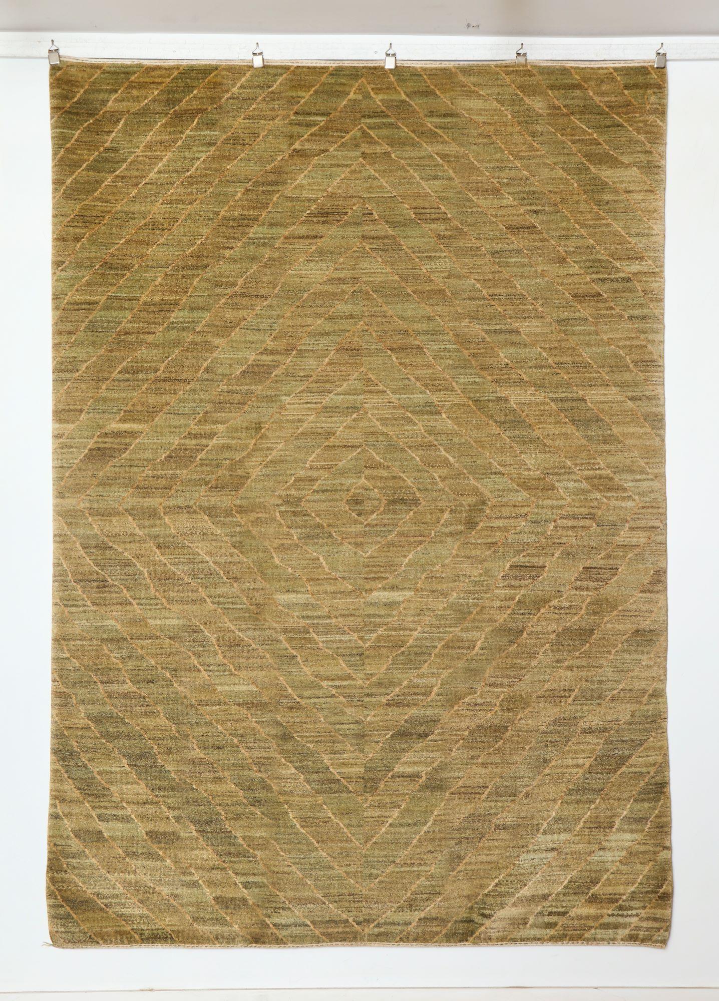 Elevating subtlety into statement, this hand-knotted organic modern Persian carpet in soft olive and taupe, measuring 5' x 7' brings a refined, design-forward aesthetic to any interior. Hand-knotted from high-quality wool, the carpet features a