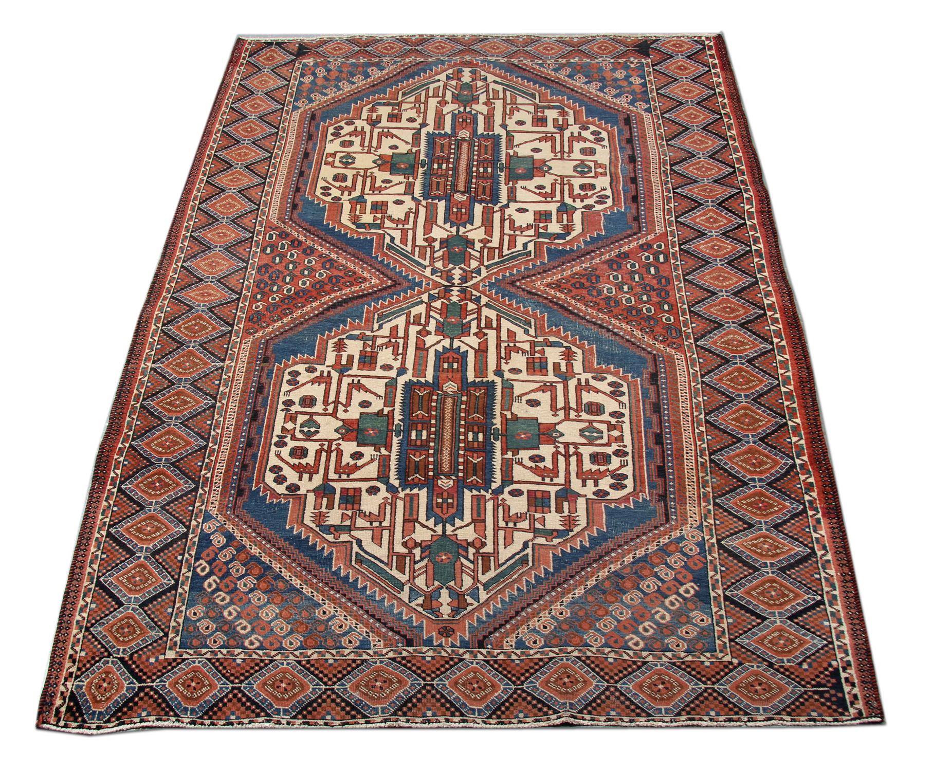 This Traditional wool carpet was handwoven in Ashfar. Hand-spun wool and cotton have been used in the construction, dyed using organic vegetable dyes. The two symmetrical central medallions have intricate motifs woven in colours of green, red and