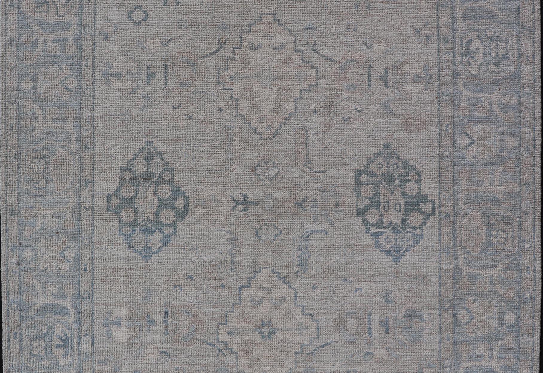Hand-Knotted Oushak with a Light Blue Background and Tribal Motifs For Sale 1