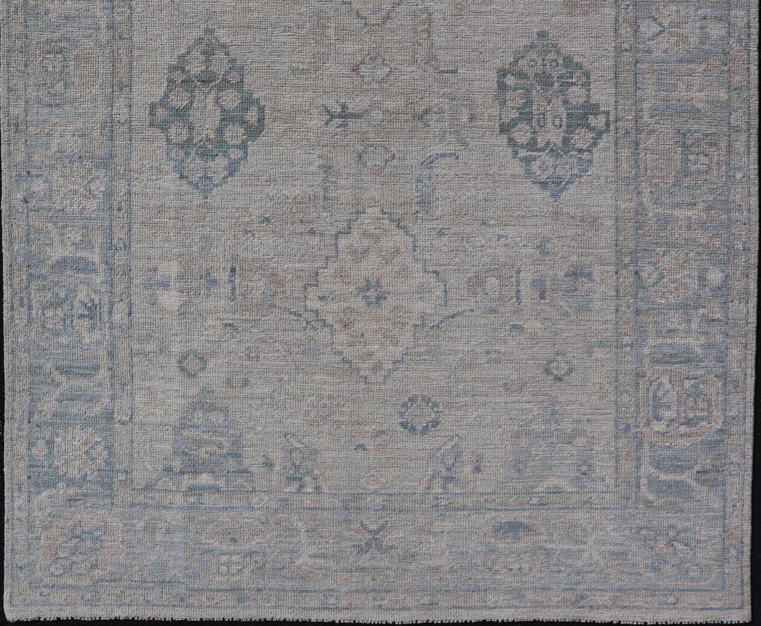 Hand-Knotted Oushak with a Light Blue Background and Tribal Motifs For Sale 2