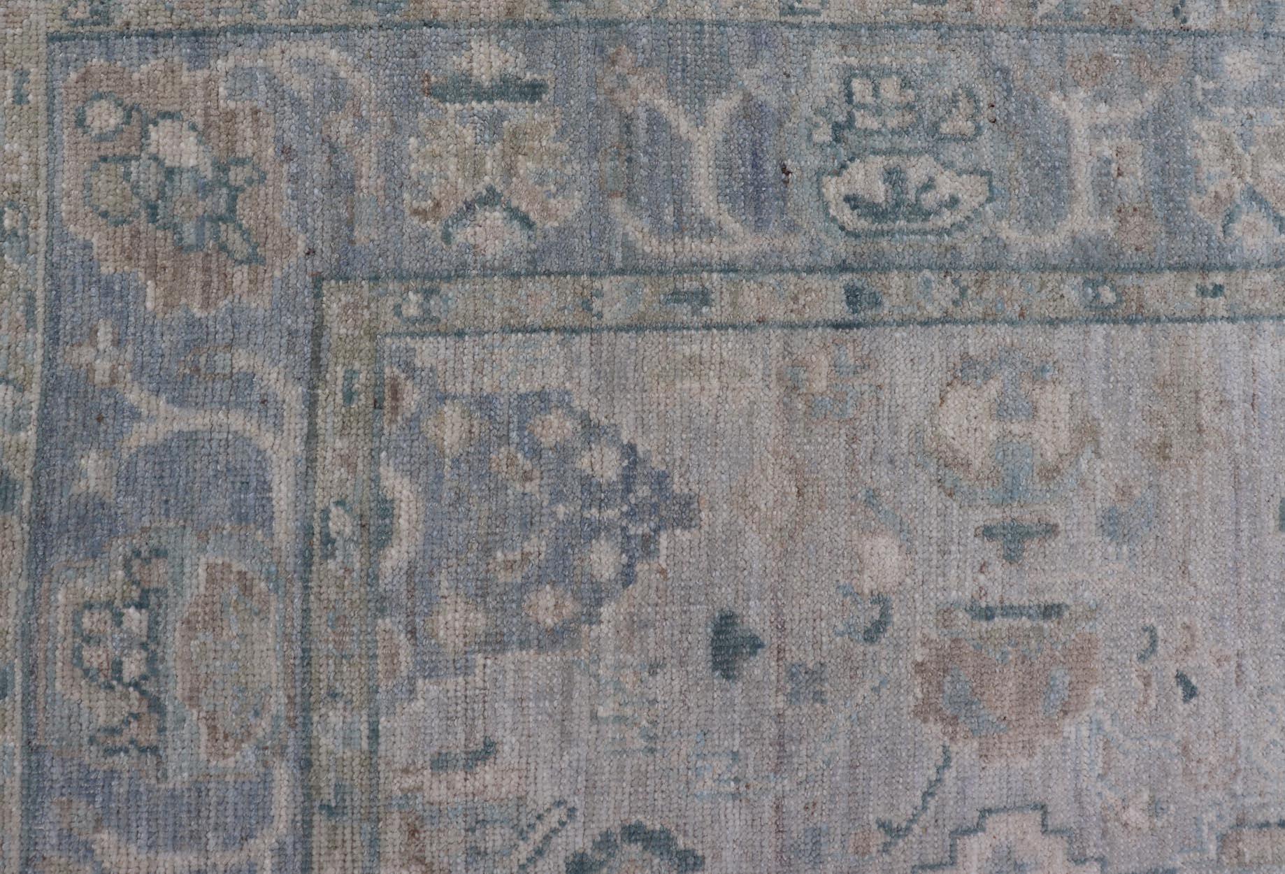 Hand-Knotted Oushak with a Light Blue-Gray Background and Tribal Motifs In New Condition For Sale In Atlanta, GA