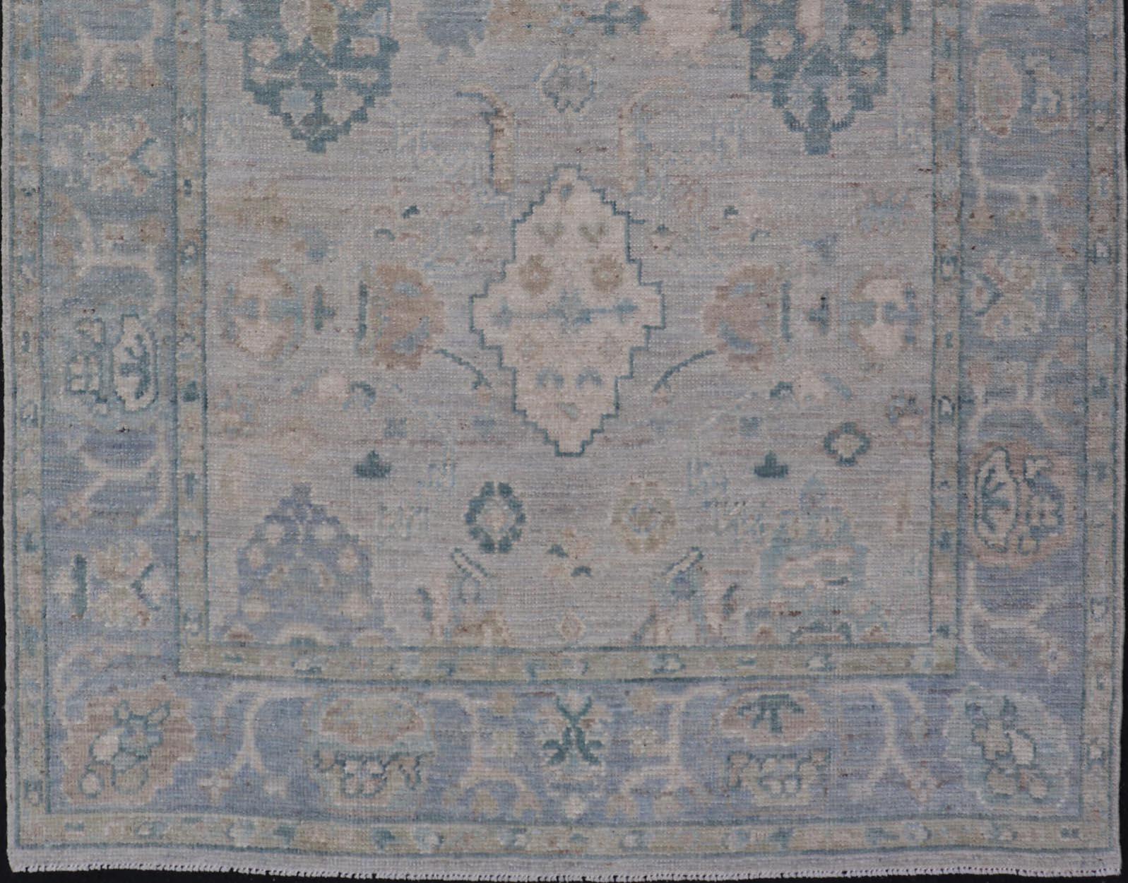 Hand-Knotted Oushak with a Light Blue-Gray Background and Tribal Motifs For Sale 1