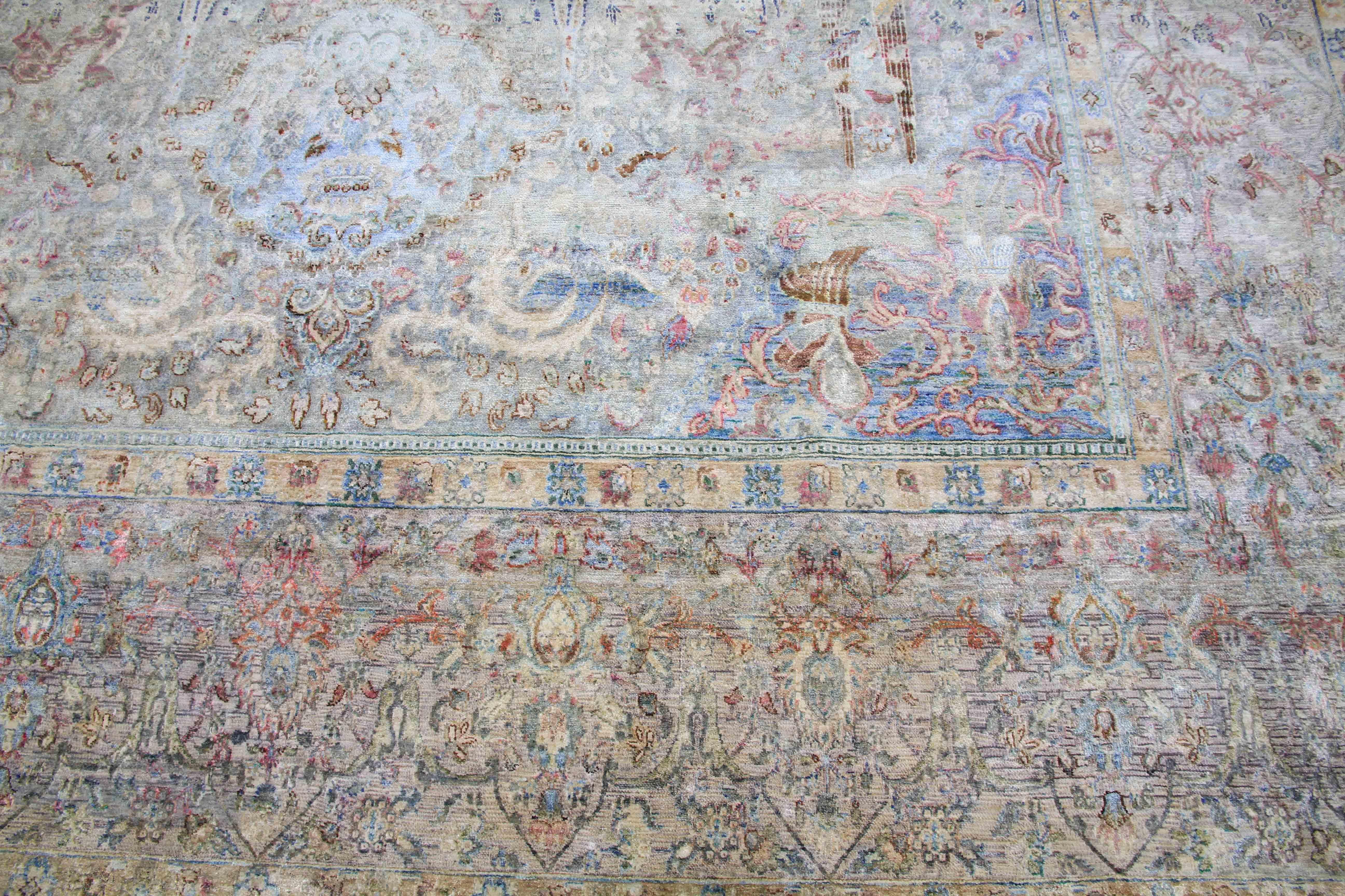 This hand-knotted oversized silk rug is a true masterpiece, crafted from vintage handspun silk and woven into a beautiful hunting design that shifts and shimmers with the light. Measuring 10'7''x17'4'', this rug is the perfect size for larger living