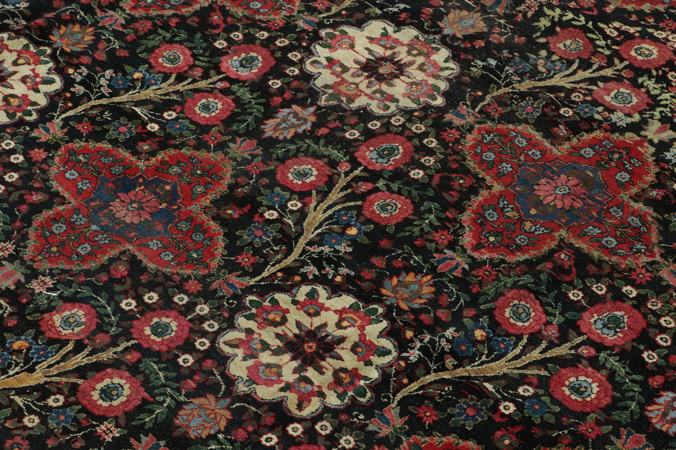 Early 20th Century Antique Persian Rug in Black with Red Floral Patterns - by Rug & Kilim For Sale
