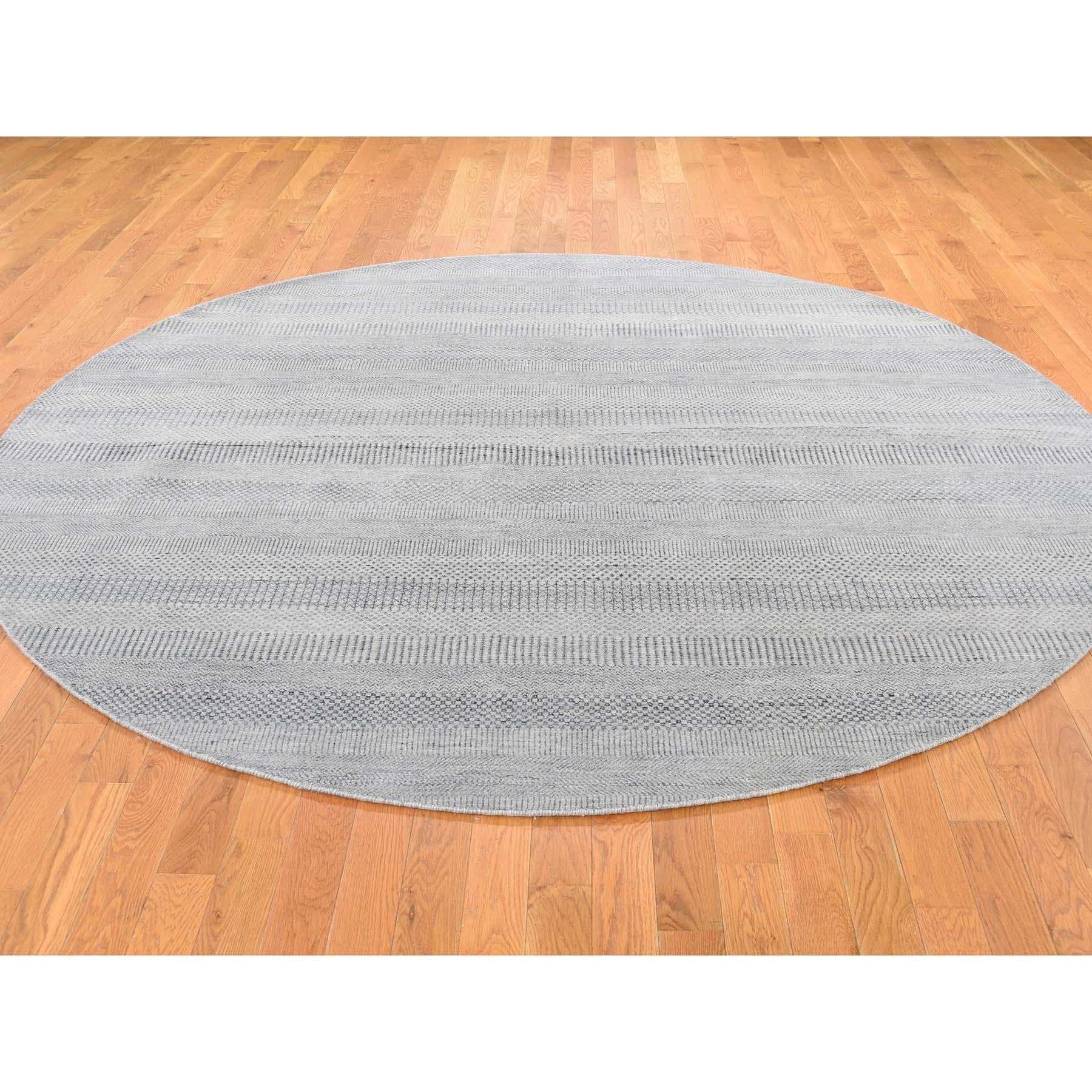 This is a truly genuine one-of-a-kind hand knotted wool and silk grass design round Oriental rug. It has been knotted for months and months in the centuries-old Persian weaving craftsmanship techniques by expert artisans. Measures: 8'0