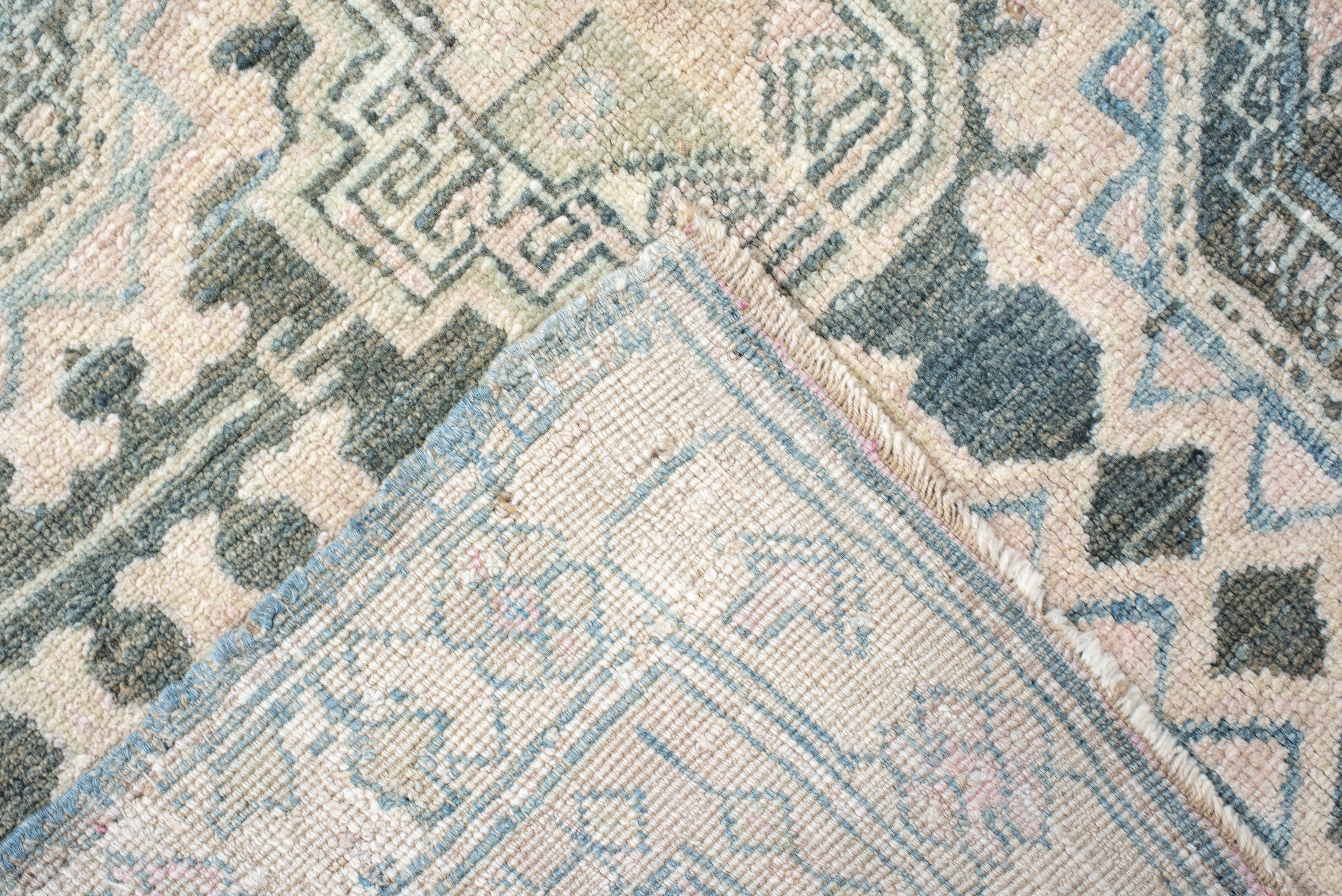 From the mountain village of Sarab in northwest Iran, this long runner arranges a column of twelve serrated octagon medallions on an ivory stonewash ground. Soft shades of glacier aqua, sea-glass teal, and parchment beige create a cool, airy mood,