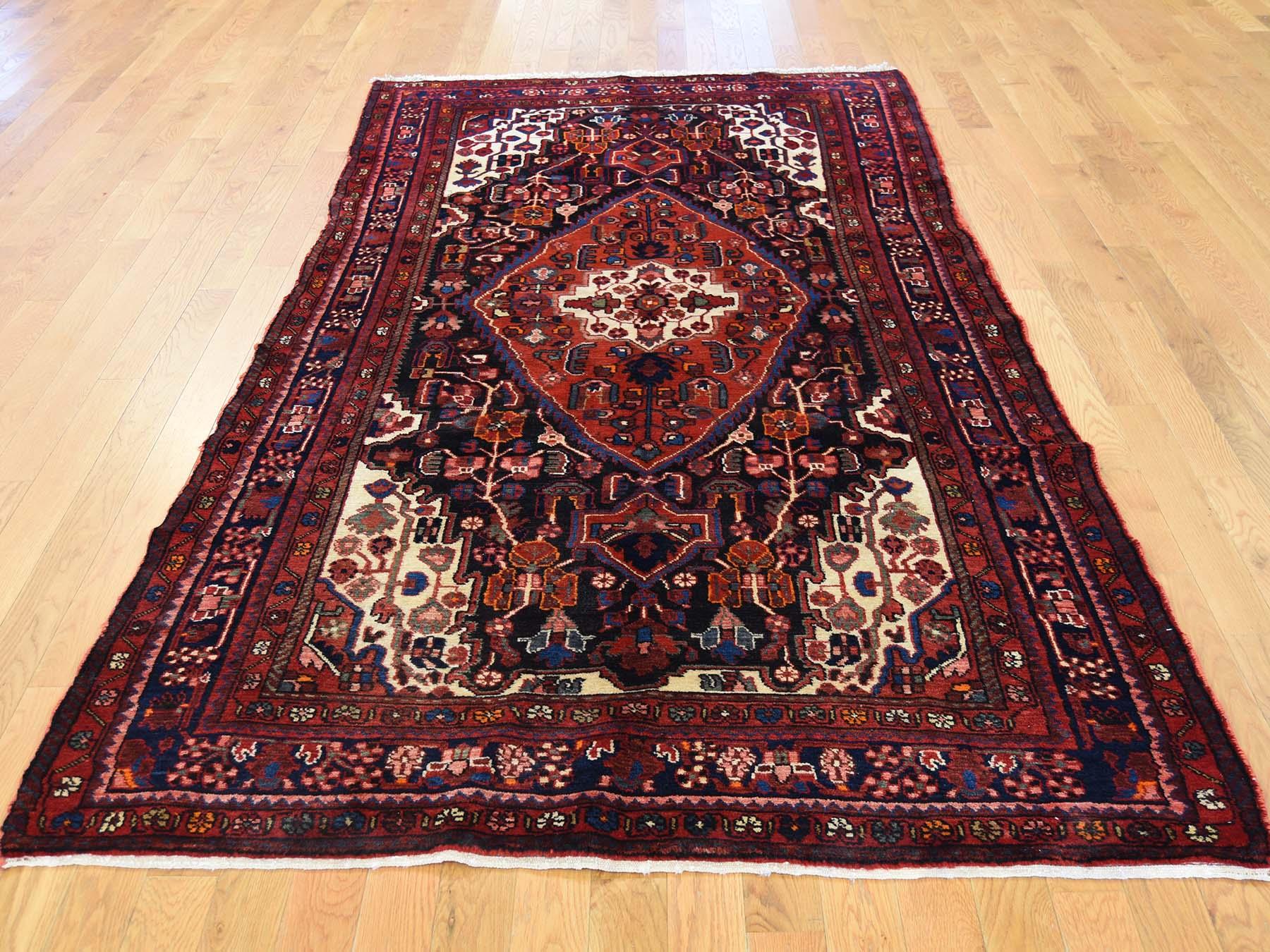 This is a truly genuine one-of-a-kind hand knotted semi antique Persian Nahavand wide runner rug. It has been knotted for months and months in the centuries-old Persian weaving craftsmanship techniques by expert artisans.

Primary materials: