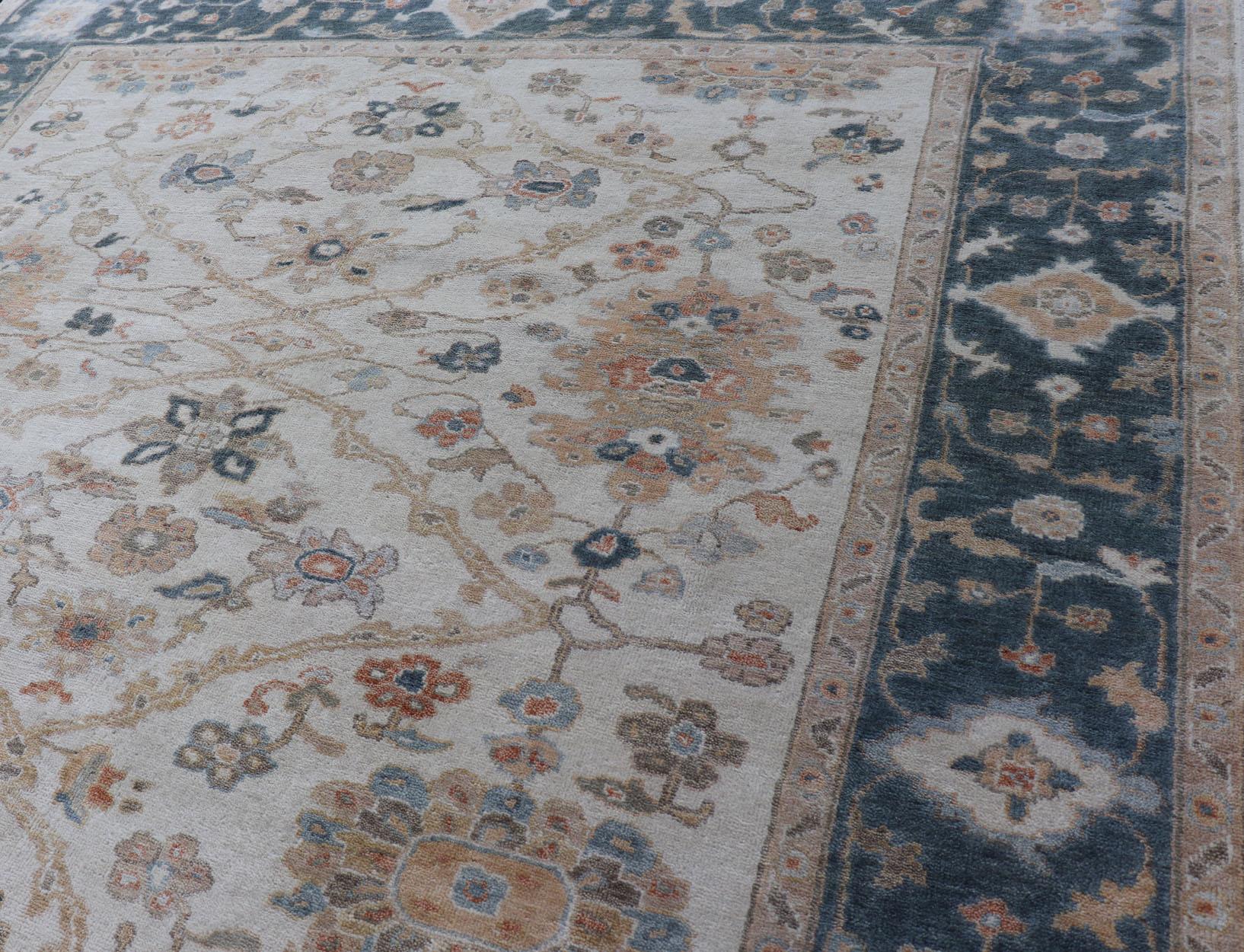 Oushak Design-Teppich von Keivan Woven Arts in Teal Blau, Creme und mehrfarbigen Farben
Maße 7'9 x 9'9
Dieser Oushak wurde in Indien von Hand geknüpft und ist fein gewebt. Die cremefarbene Mitte enthält ein einzigartiges Design mit gemeinsamen