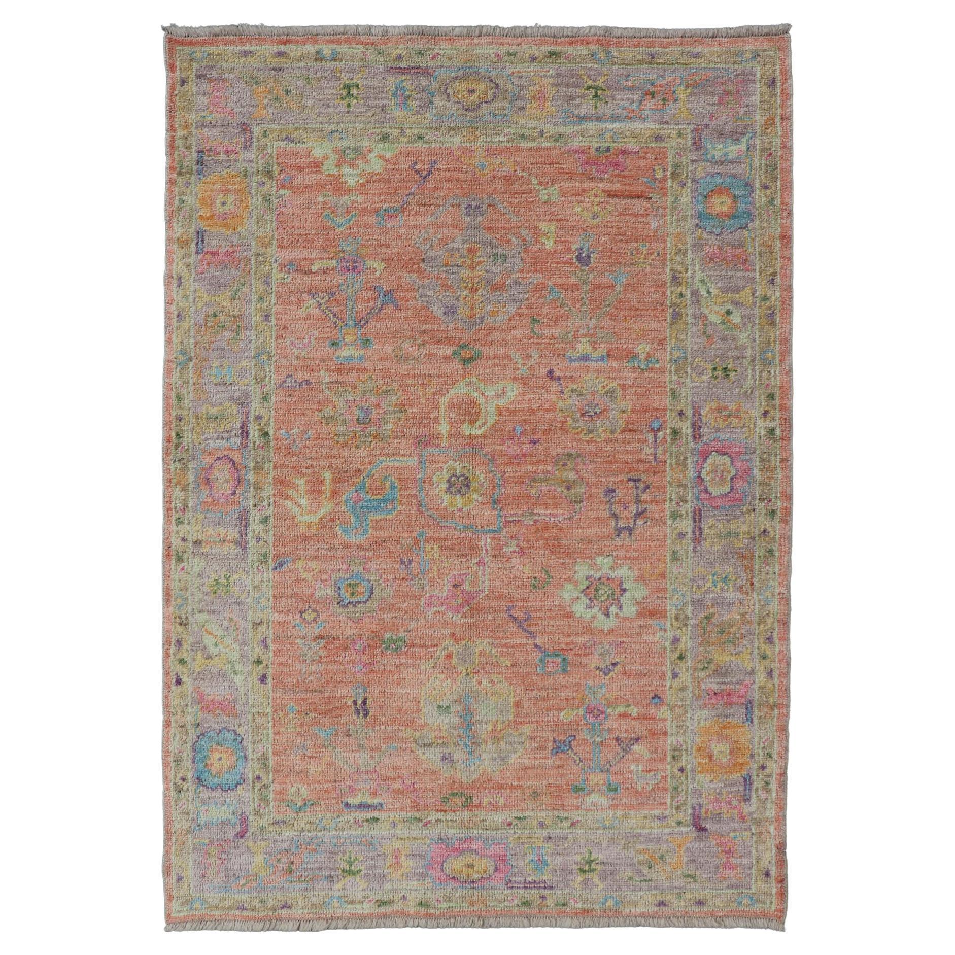 Hand Knotted Turkish Floral Oushak with Orange Background and Lilac Border  For Sale