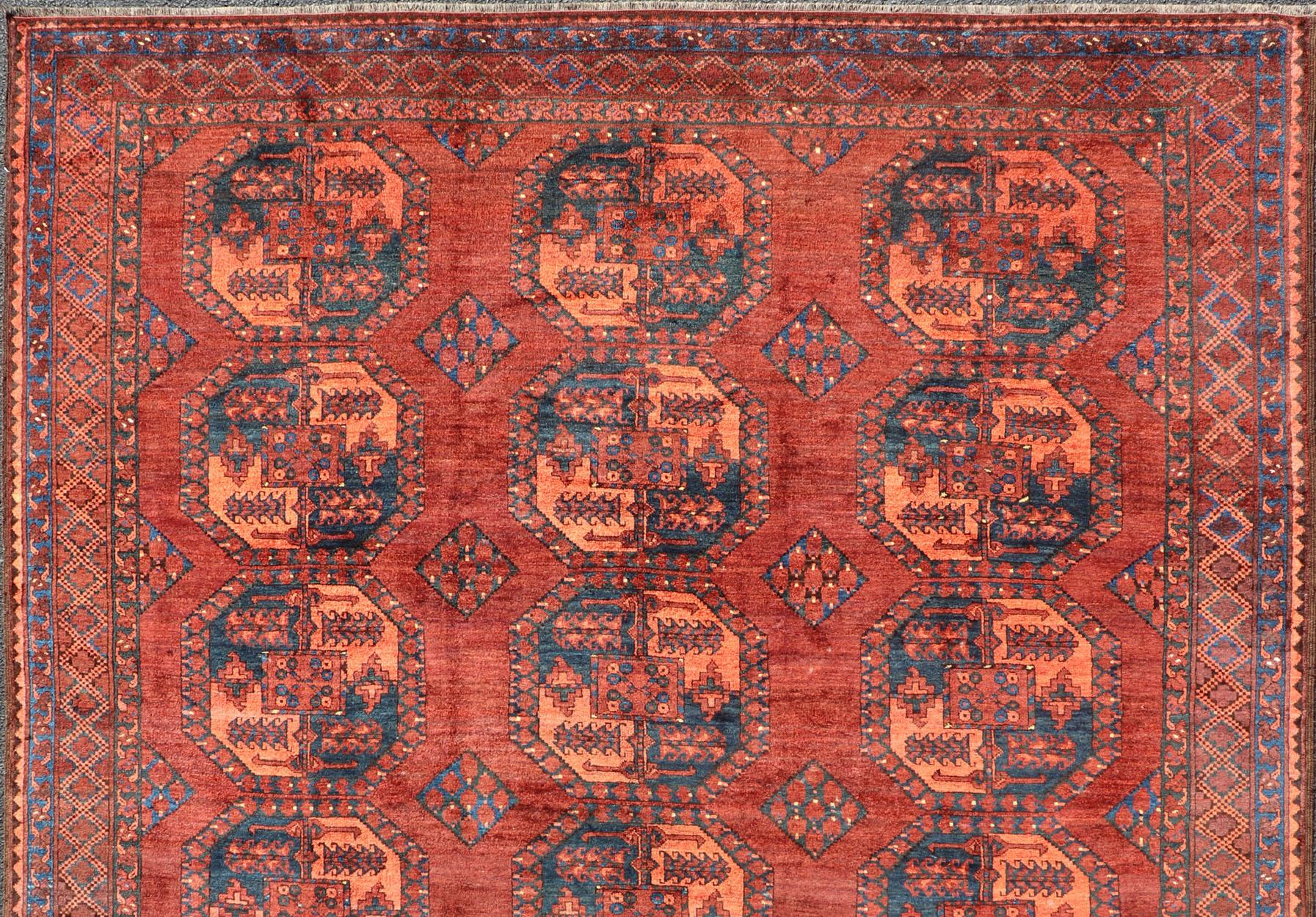 This Turkomen Ersari rug has been hand-knotted in the finest wool. The rug features a repeating Gul design throughout the entirety of the rug, enclosed within a complementary, multi-tiered border, depicting small repeating motifs. The rug is