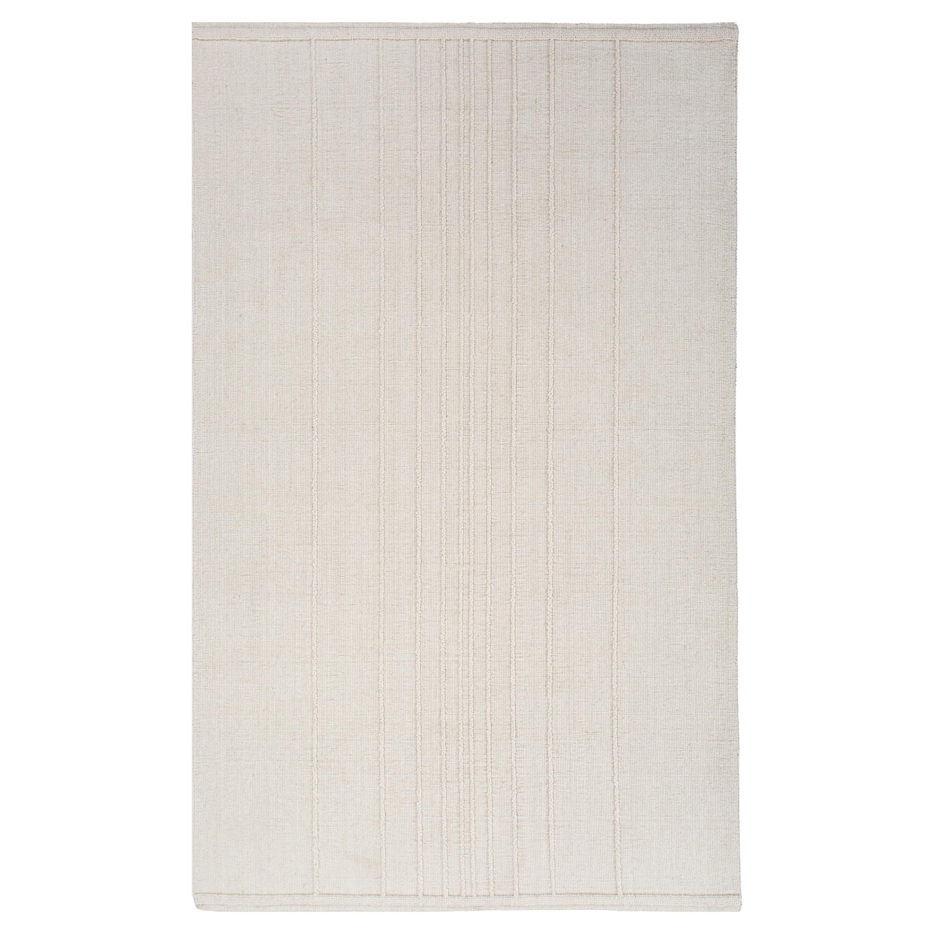 Alfombra de lana sin teñir anudada a mano en blanco natural, diseño minimalista respetuoso con el medio ambiente