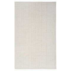 Alfombra de lana sin teñir anudada a mano en blanco natural, diseño minimalista respetuoso con el medio ambiente