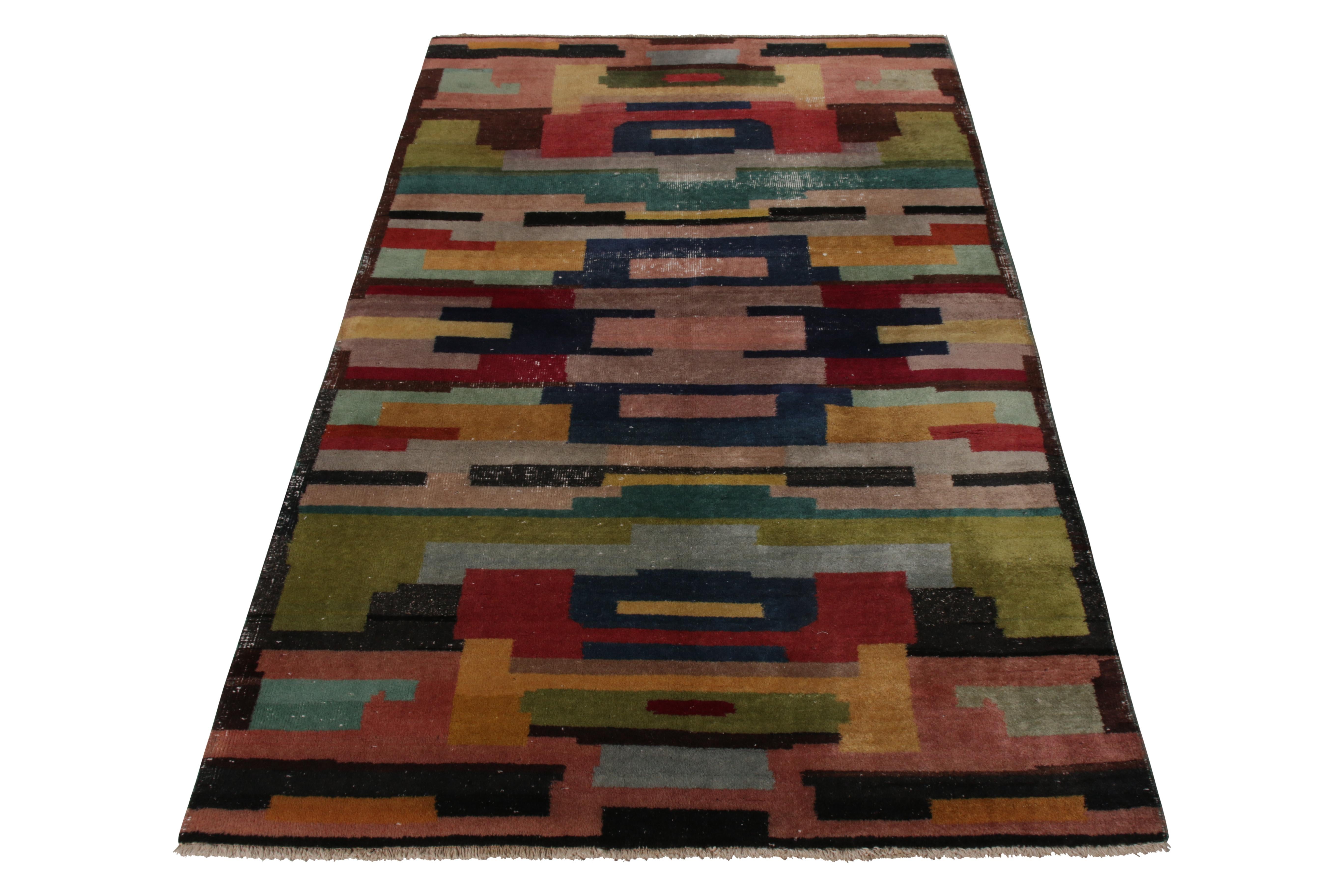 A vintage 4 x 8 rug connoting a mid-century Deco style, hand knotted in wool originating from Turkey, circa 1950-1960. Hand knotted in wool, enjoying a whimsical, delicious palette of pinks, browns, reds, and blues among near-countless colors.