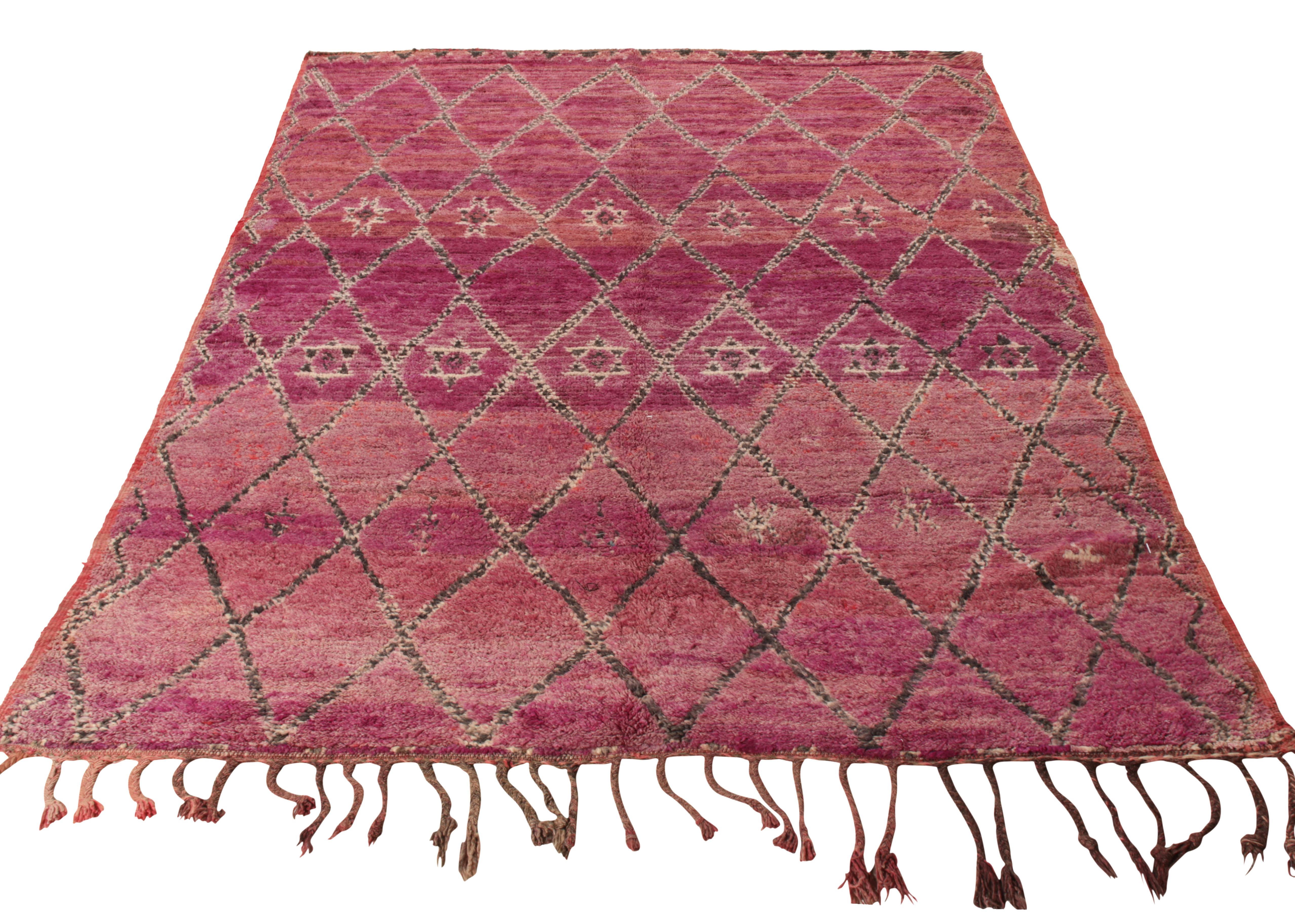 A beautiful, hand-knotted vintage 7x10 Moroccan rug, originating circa 1950-1960. Flourishing in a gracious scale, the rug originating from a particular community of Moroccan Jews who were rarely seen owning looms or making carpets, especially