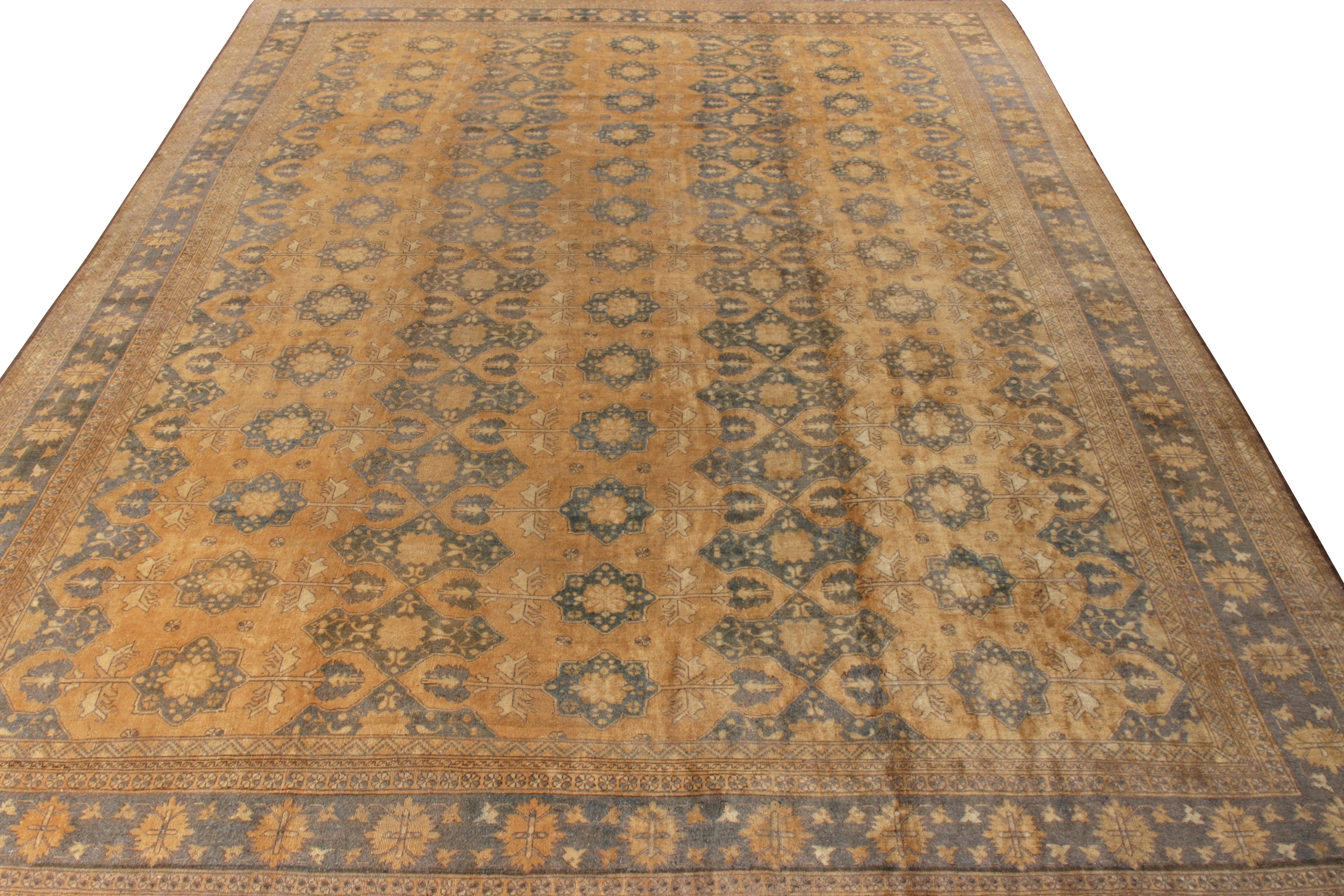 Originating from Afghanistan circa 1950-1960, a handknotted vintage wool Ottoman rug from Rug & Kilim’s coveted Antique & Vintage collection. This 13x16 piece features an all over classic floral design in rich golden-brown and blue hues for a regal