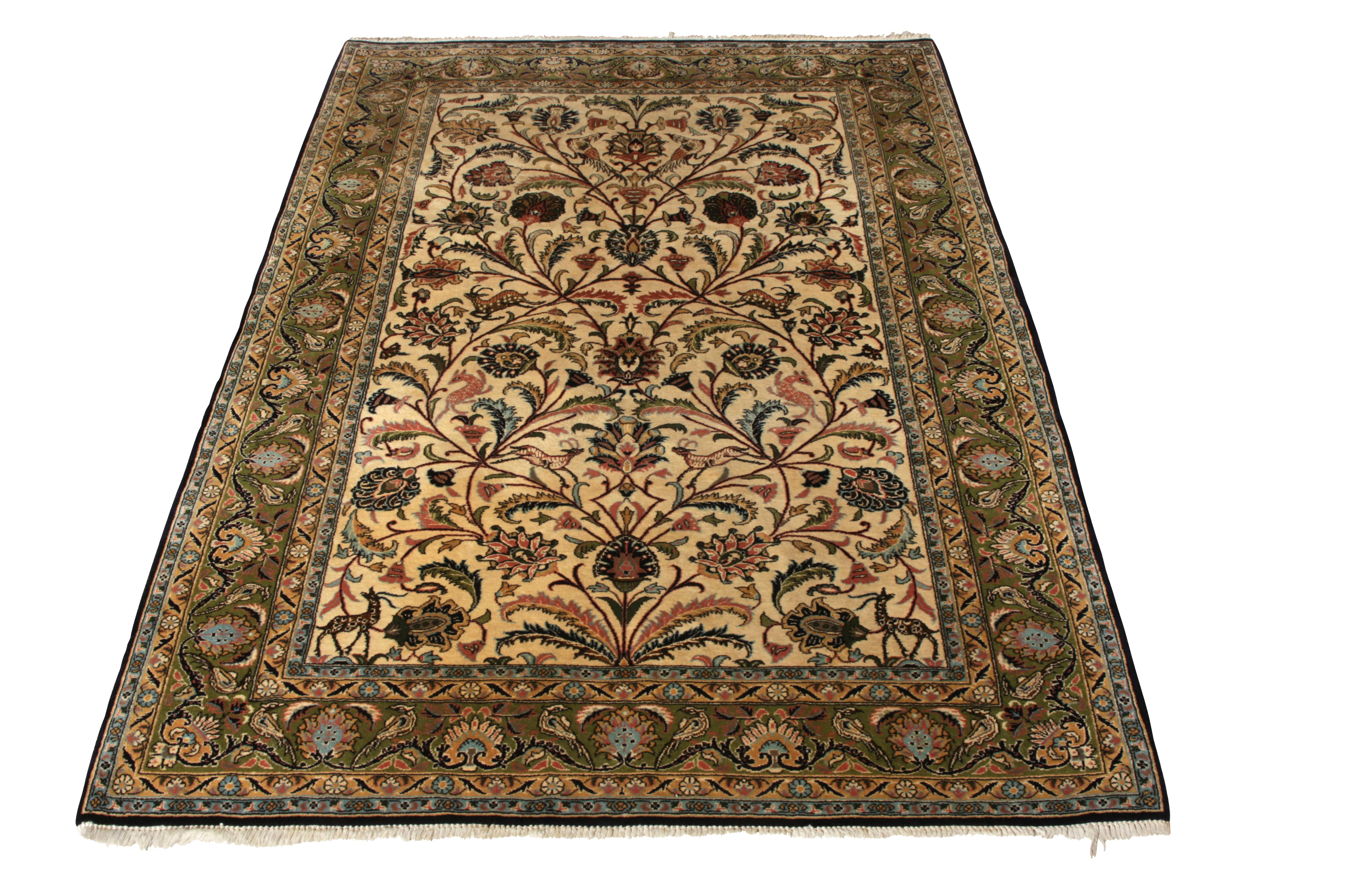 Connoting the fine aesthetics of traditional design in hand-knotted silk, this vintage 5x7 Persian rug of Qum lineage spins a tale of finesse through an ostentatious floral- pattern with a fabulous sense of movement. Originating circa 1950-1960, the