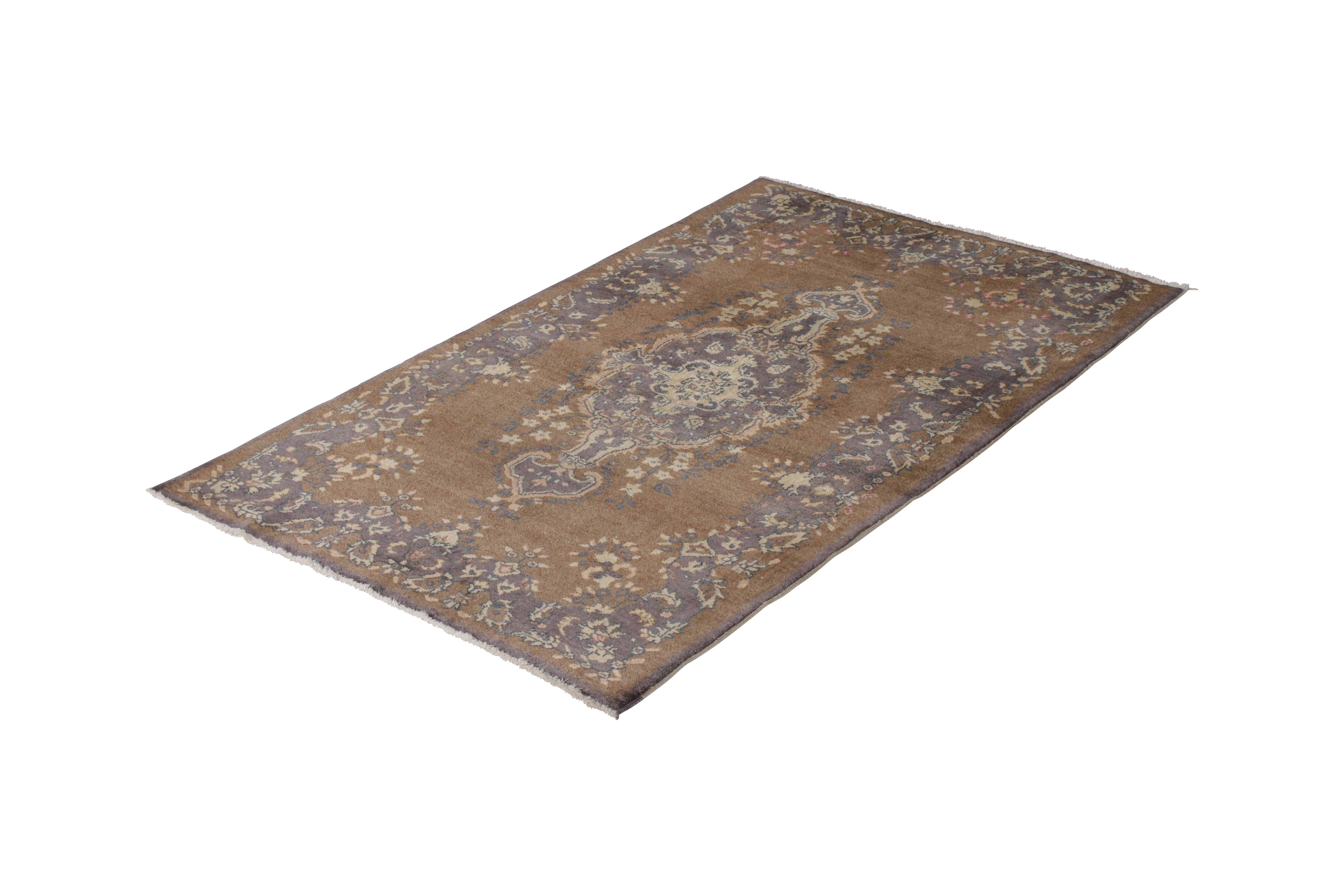 A 4 x 6 vintage rug of Sivas design, hand-knotted in wool originating from Turkey circa 1950-1960. A rare sibling of two 4 x 6 pieces, both in variations of this comfortable beige-brown, blue, and purple play. Available individually and together