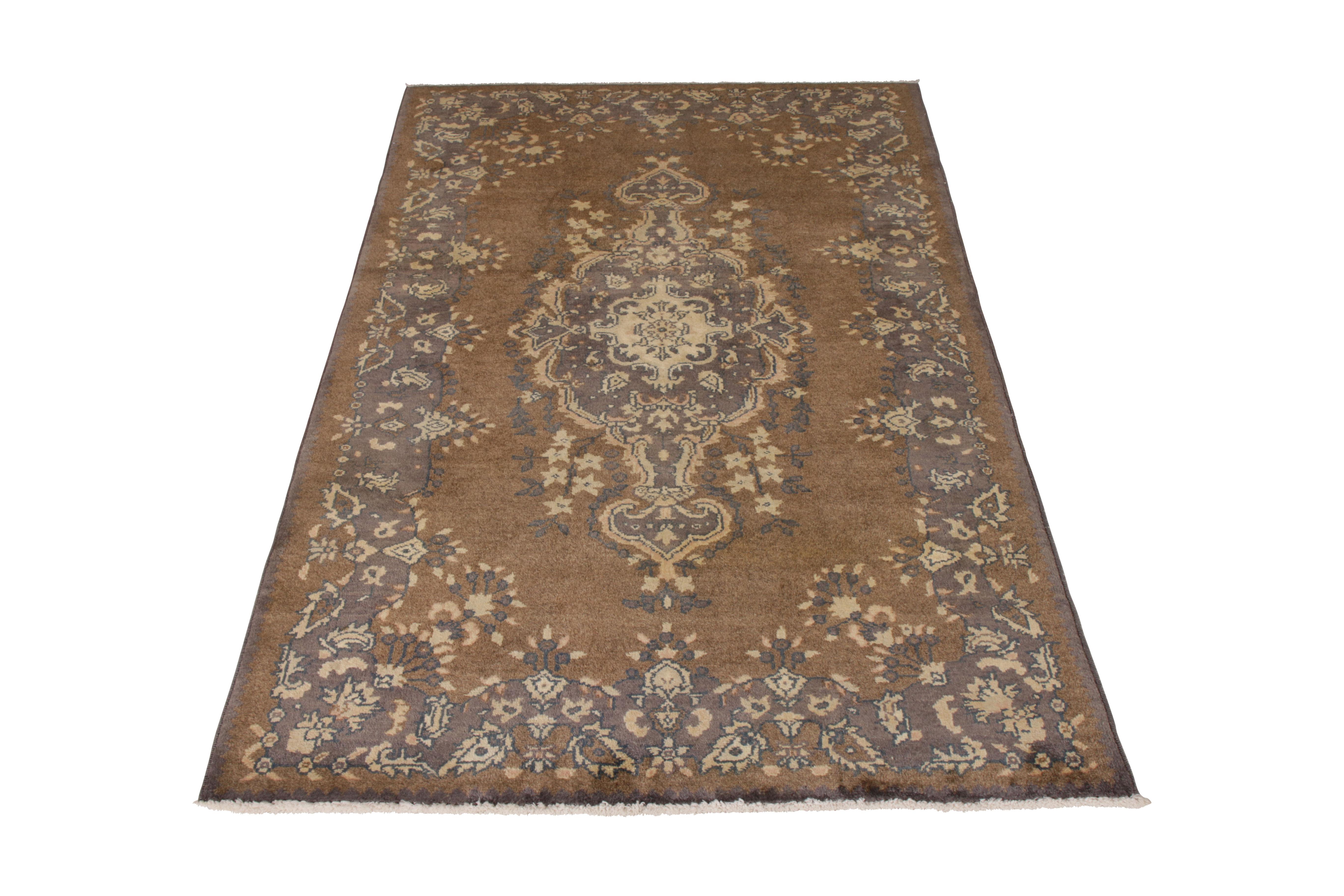 A 4x6 vintage rug of Sivas design, hand-knotted in wool originating from Turkey circa 1950-1960. A rare sibling of two 4x6 pieces, both in variations of this comfortable beige-brown, blue, and purple play. Available individually and together upon