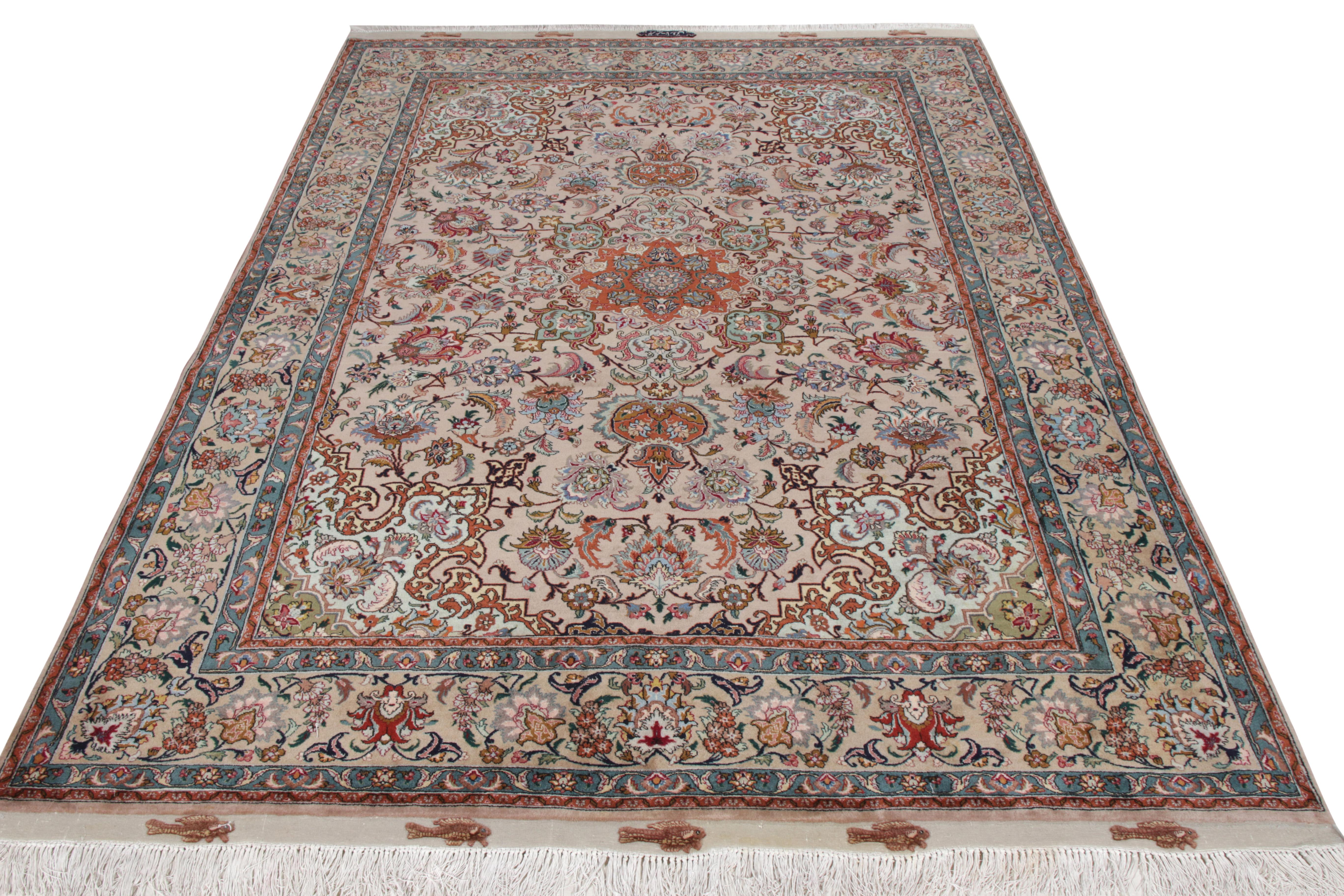 A 6x9 hand-knotted mid-century Tabriz rug joining Rug & Kilim’s coveted Antique & Vintage collection. Hailing from a fine Persian workshop of the 1950s, this vintage rug enjoys a striking Medallion in red while being encased in a dense floral