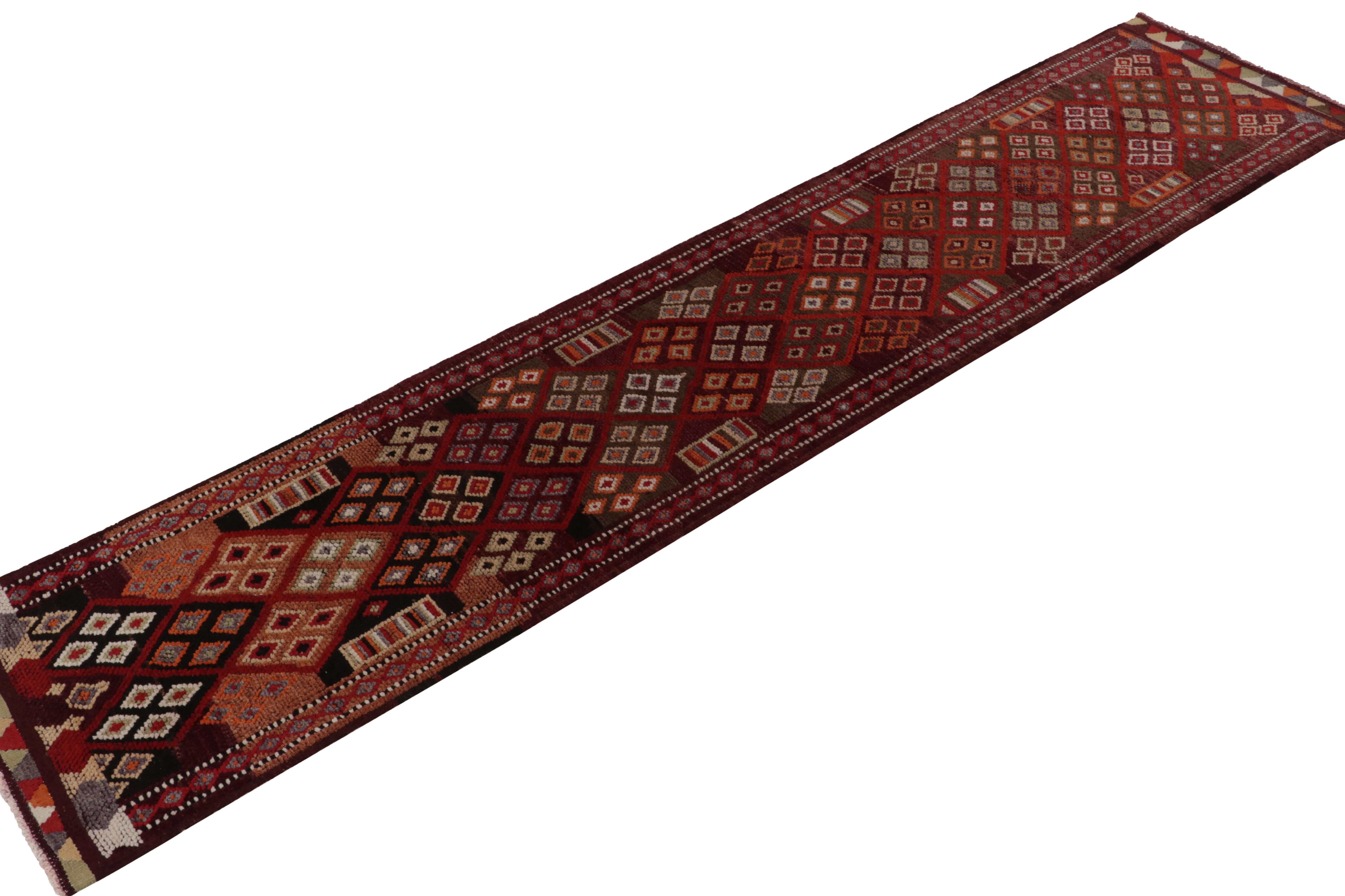 This mid-century 3x14 runner hails from a profound curation of vintage Turkish tribal rugs, hand-knotted in wool circa 1950-1960. 

The design favors rich, sanguine red with underlying brown towns, accented by black and orange among many varied