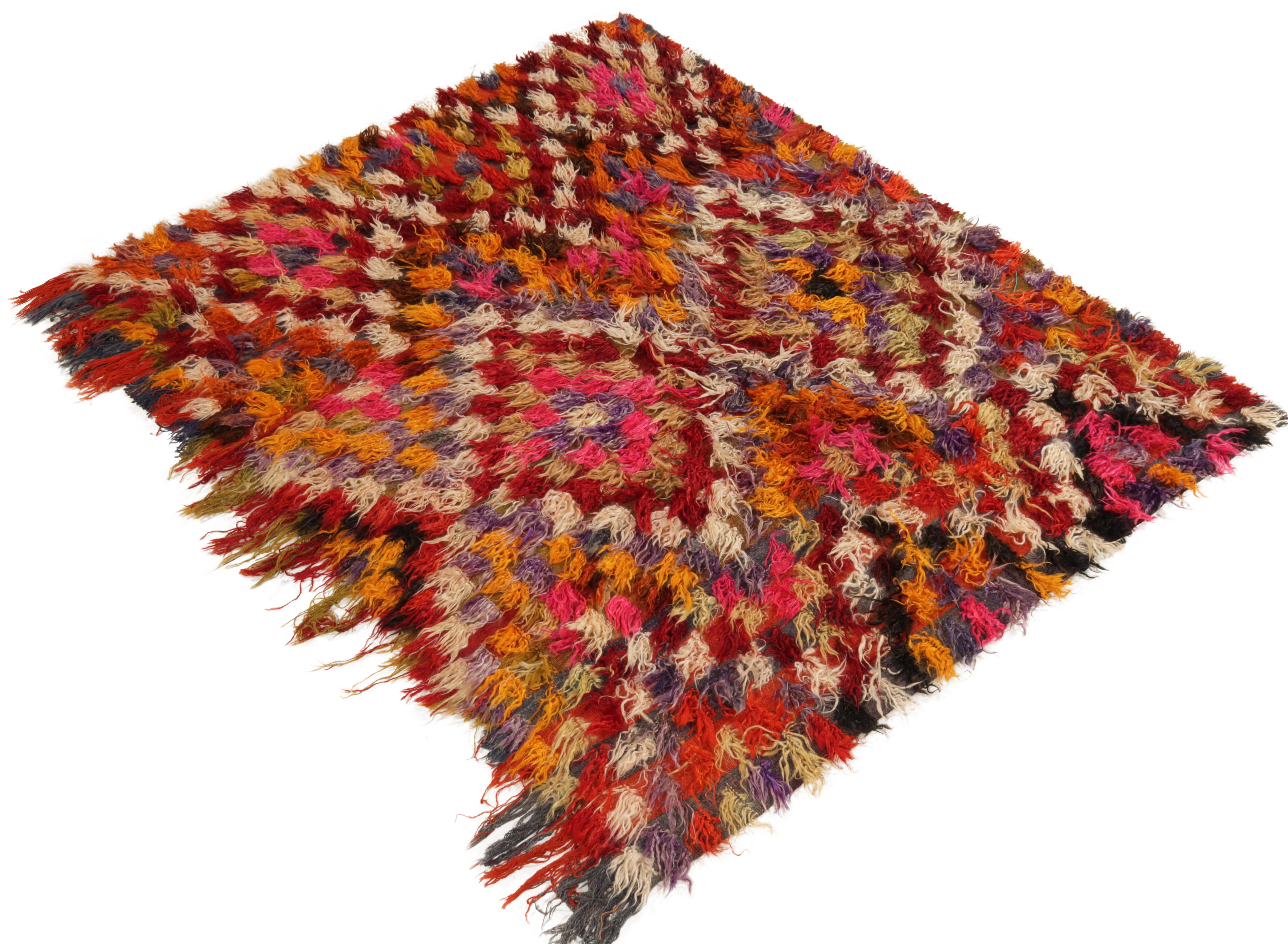 From Rug & Kilim’s Vintage selections, a hand-knotted mid-century Tulu rug carrying a luscious high pile. 

Originating from Turkey circa 1950-1960, the rug employs geometry to craft diamond patterns & chevrons in hues of red, orange, yellow,