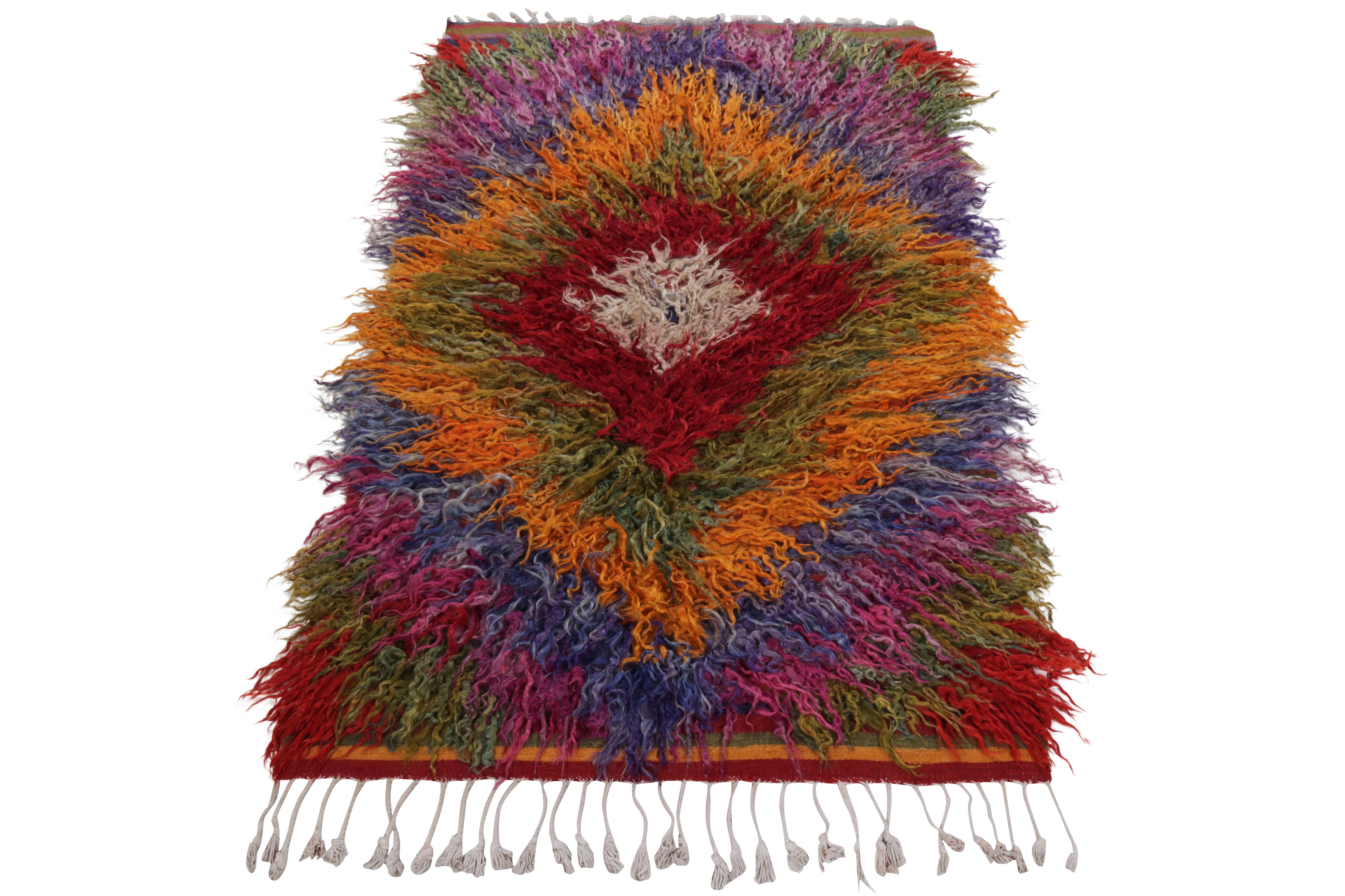 From Rug & Kilim’s Vintage selections, a 4x6 handknotted Tulu rug carrying a comforting high pile. Coming from Turkey circa 1950-1960, the tribal piece bears a striking diamond pattern in a bold colorplay of bright orange, grass green, crimson red,