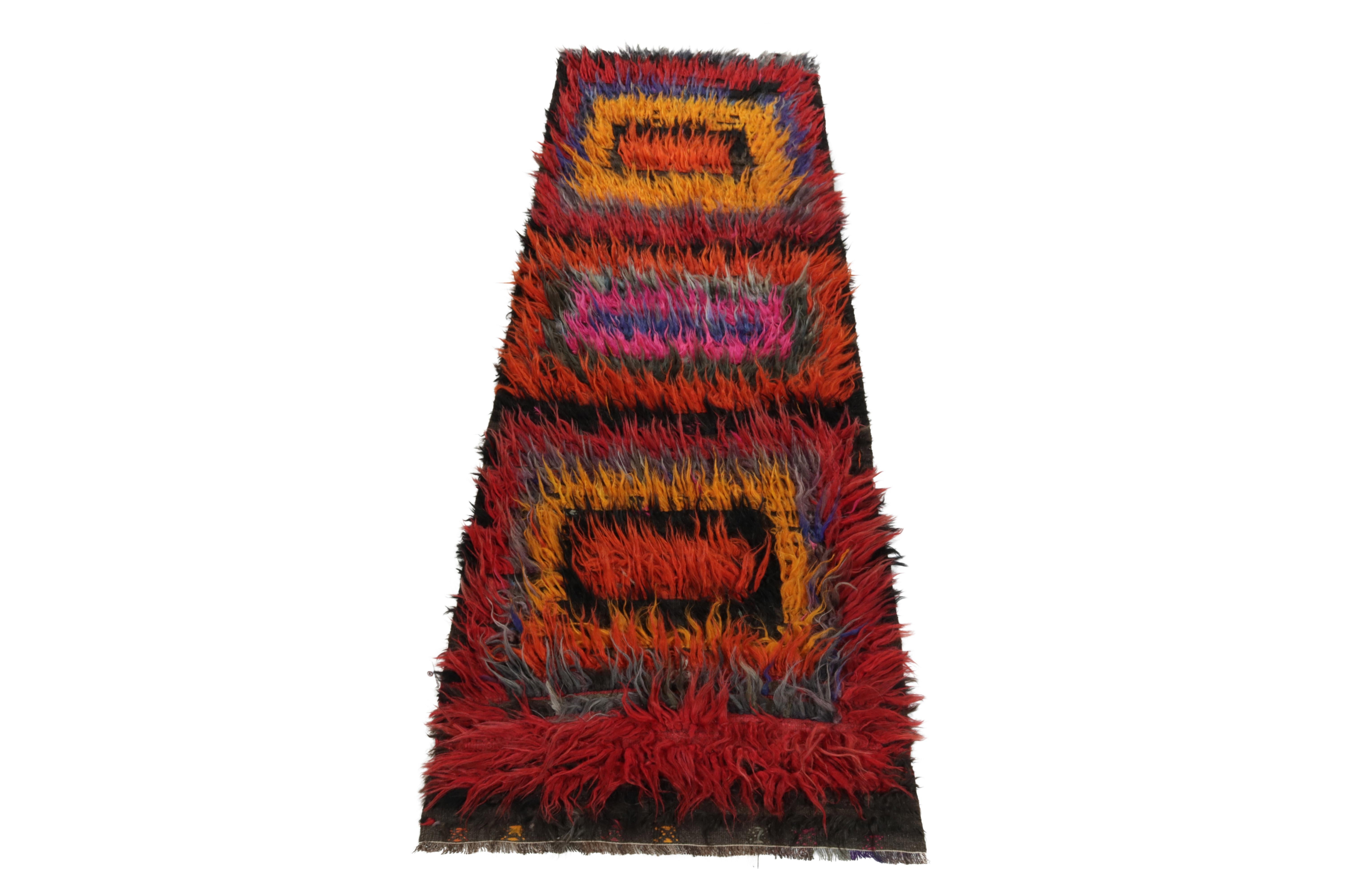 From Rug & Kilim’s vintage selections, a hand-knotted mid-century Tulu runner carrying a comforting high pile. Originating from Turkey circa 1950-1960, the rug enjoys a geometric pattern in hues of red, yellow, orange, blue & black further