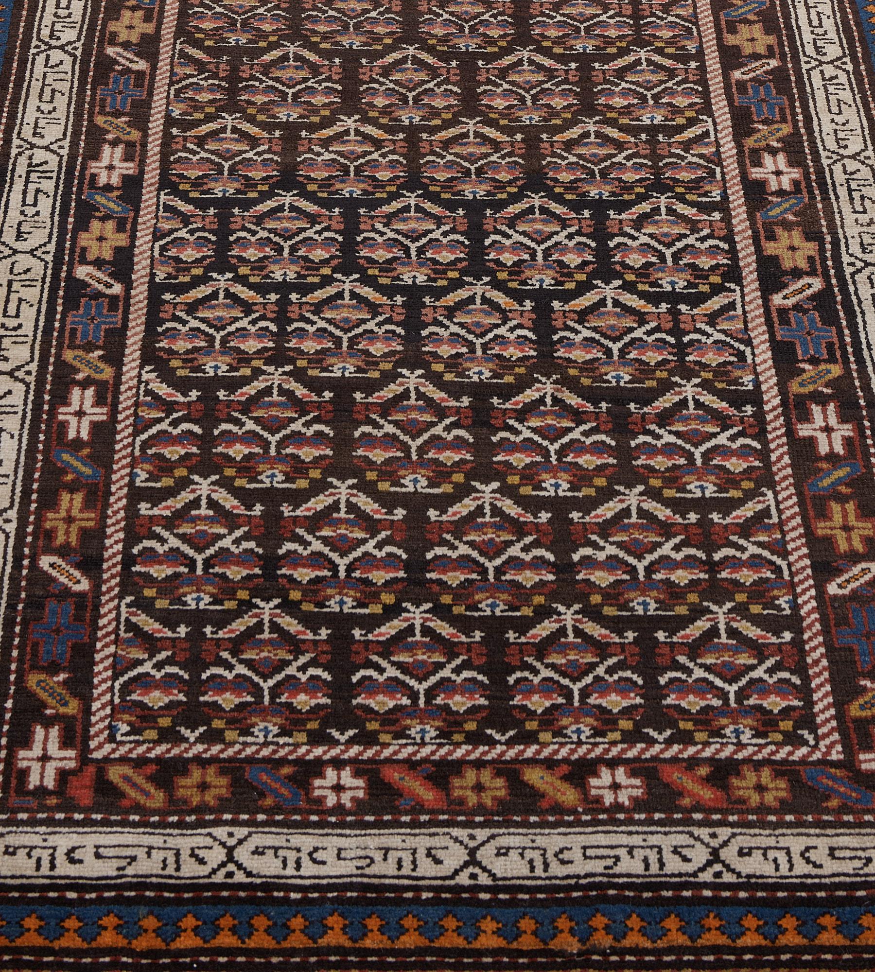 This antique, circa 1920, Persian Serab runner has a chocolate-brown field with diagonal rows of polychrome angular floral motifs enclosed within a narrow fox-brown and ivory barber-pole stripe, in a chocolate-brown border of angular polychrome