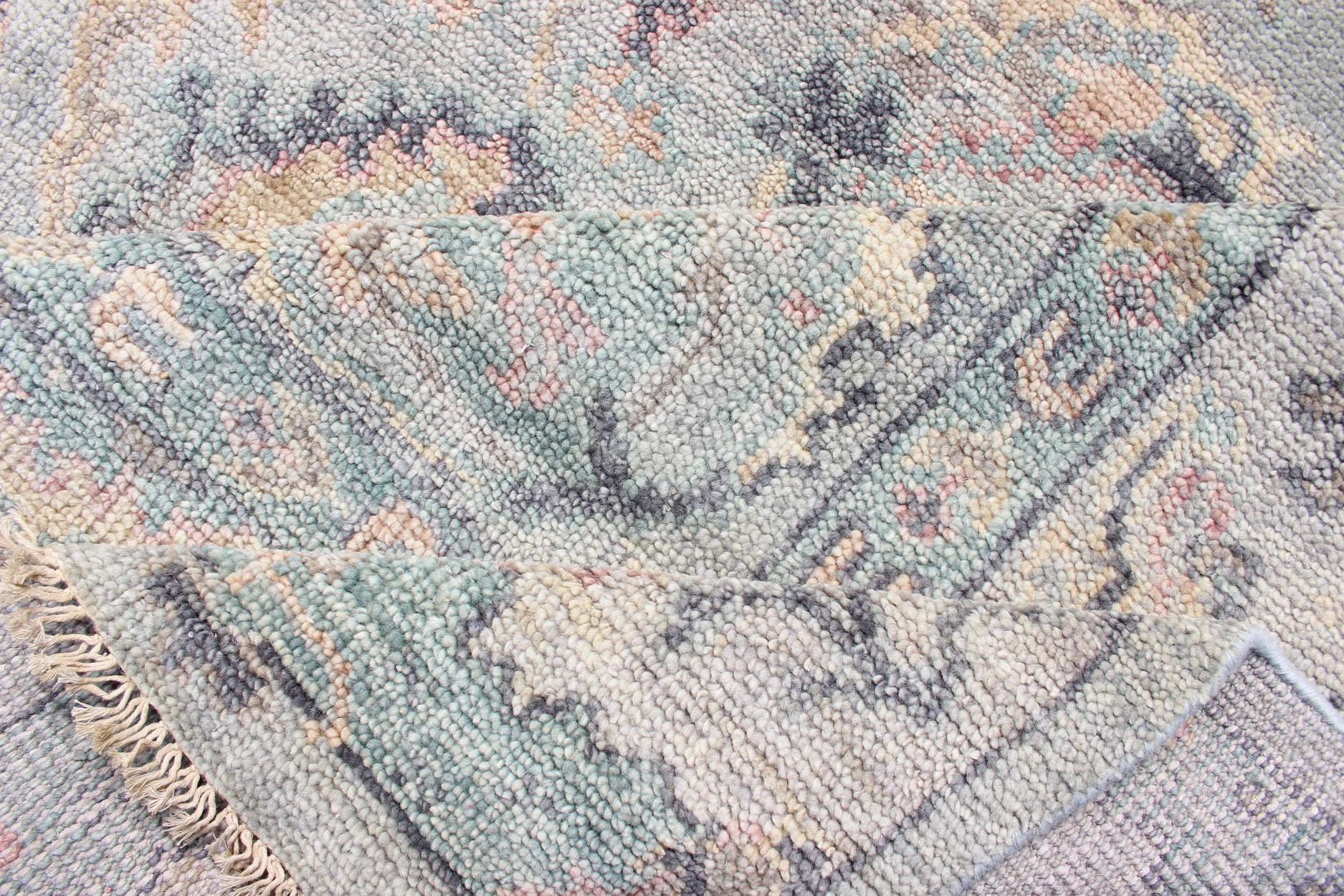 Hand Knotted Wool Oushak Rug Featuring Floral Designs in Muted Colors 7'8