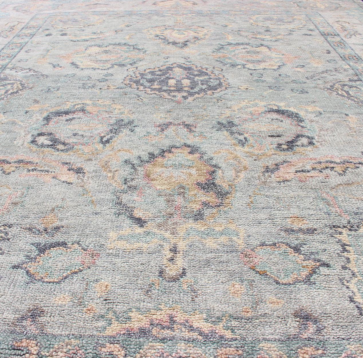 Hand Knotted Wool Oushak Rug Featuring Floral Designs in Muted Colors 7'8