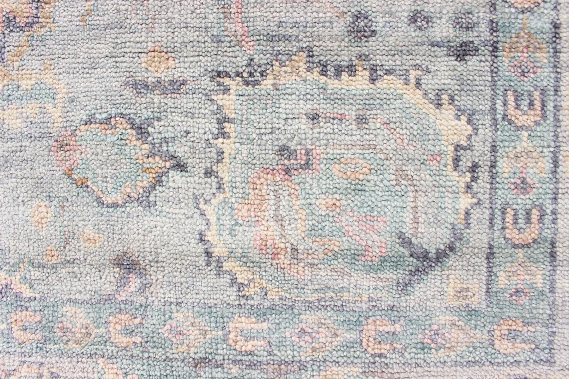 Hand Knotted Wool Oushak Rug Featuring Floral Designs in Muted Colors 7'8