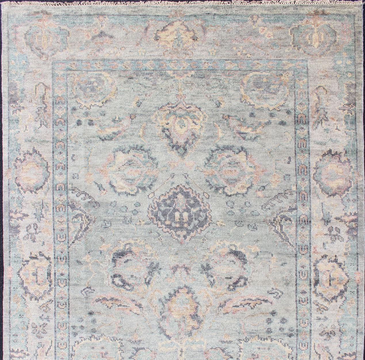 Hand Knotted Wool Oushak Rug Featuring Floral Designs in Muted Colors 7'8