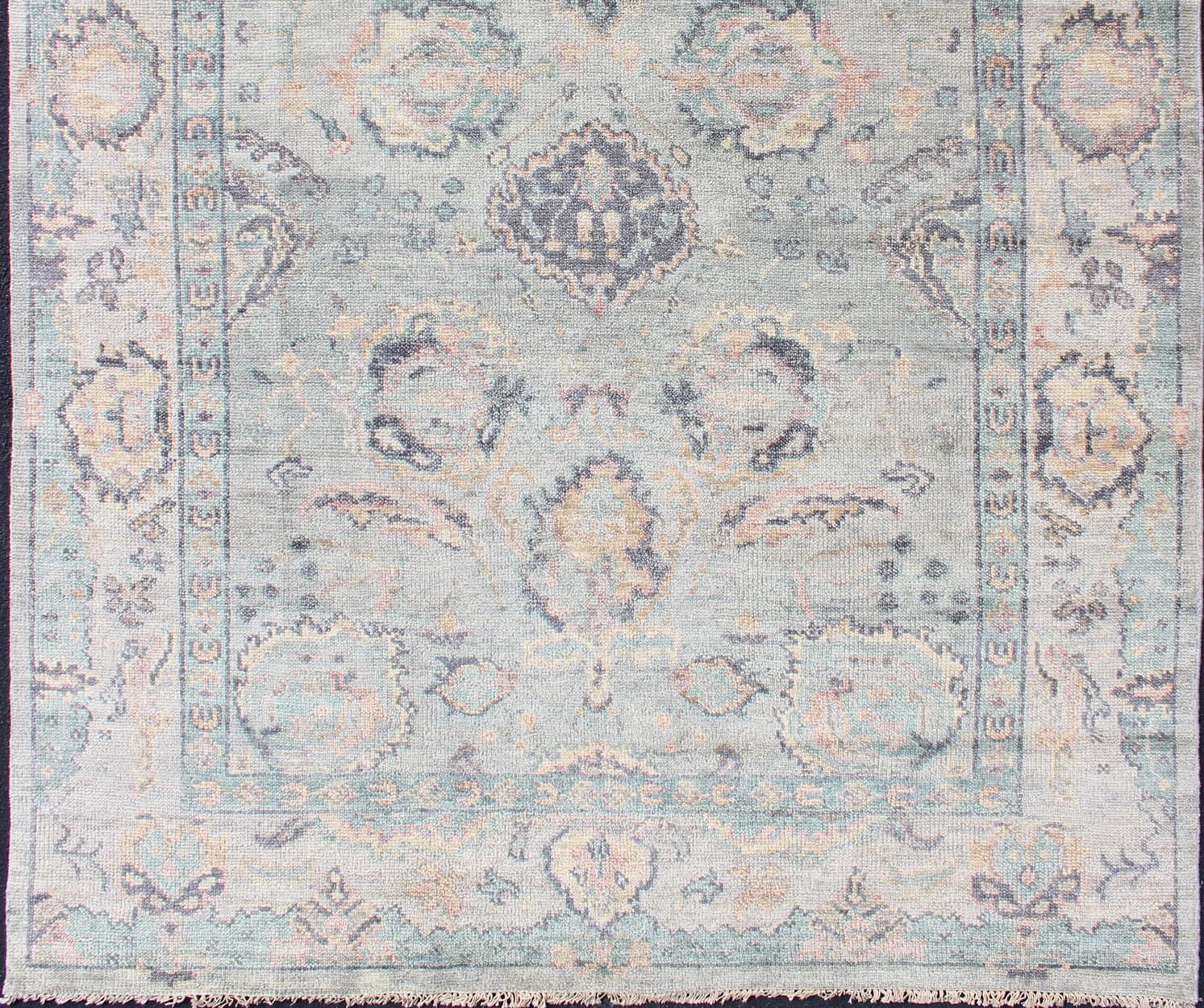 Hand Knotted Wool Oushak Rug Featuring Floral Designs in Muted Colors 7'8