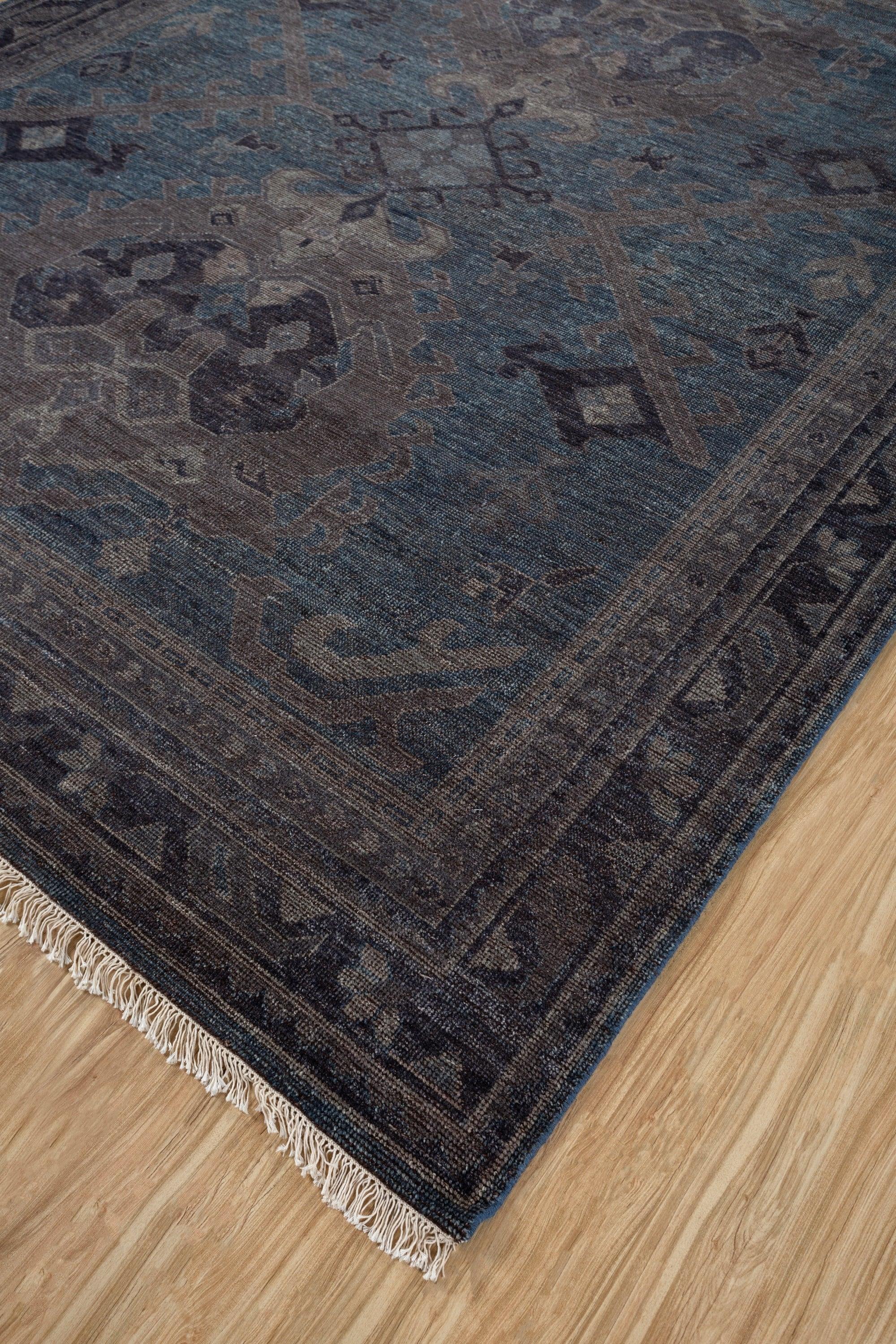 This 9' x 12' hand-knotted rug from Jaipur Rugs features a striking palette of indigo blue and marine blue, showcasing an abstract geometric design. Made from high-quality wool, the rug provides a soft, plush texture, enhancing both comfort and