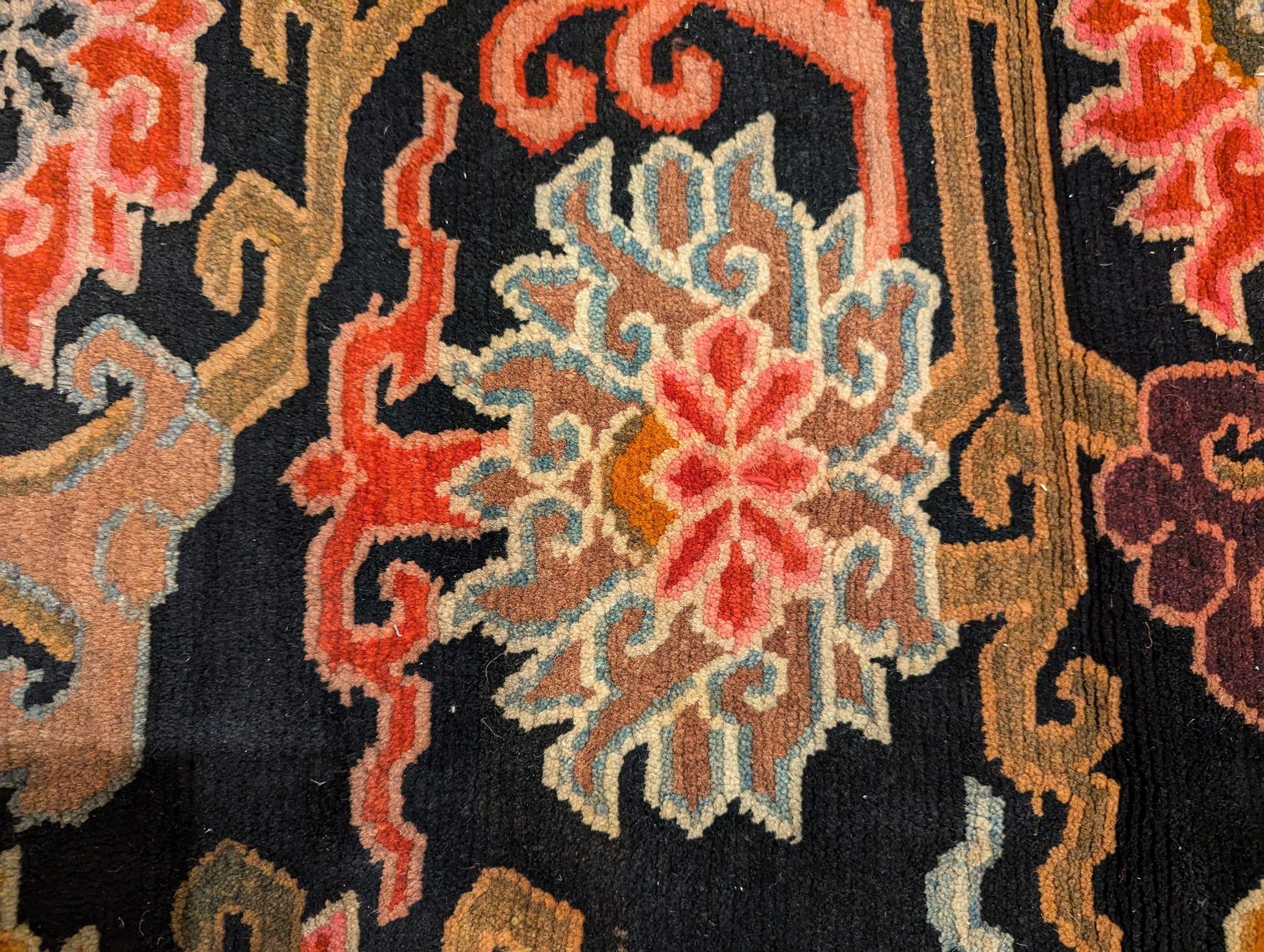 Offered is a hand-knotted on a black tinted Yak wool background are twelve distinct lotus flowers in an array of colors comprised of natural dyes that was acquired during a trip to Tibet in the 1990s. The lotus is a Buddhist symbol for purity,