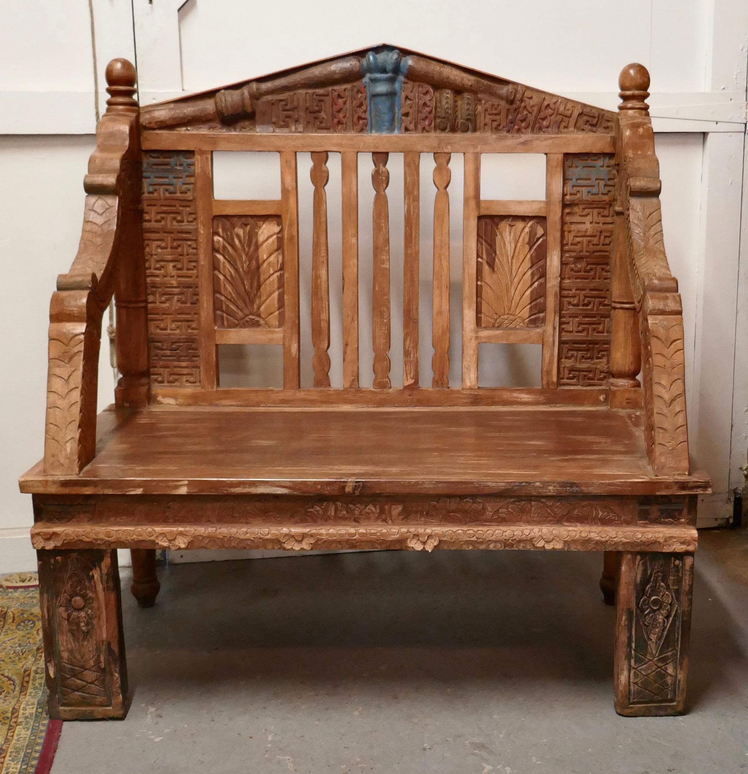 Hand made Anglo Indian Folk Art bench

 The bench has been very skilfully made using old architectural materials and carvings it is a completely unique and one off piece 
It has the most magnificent look combined with a patina which really shows