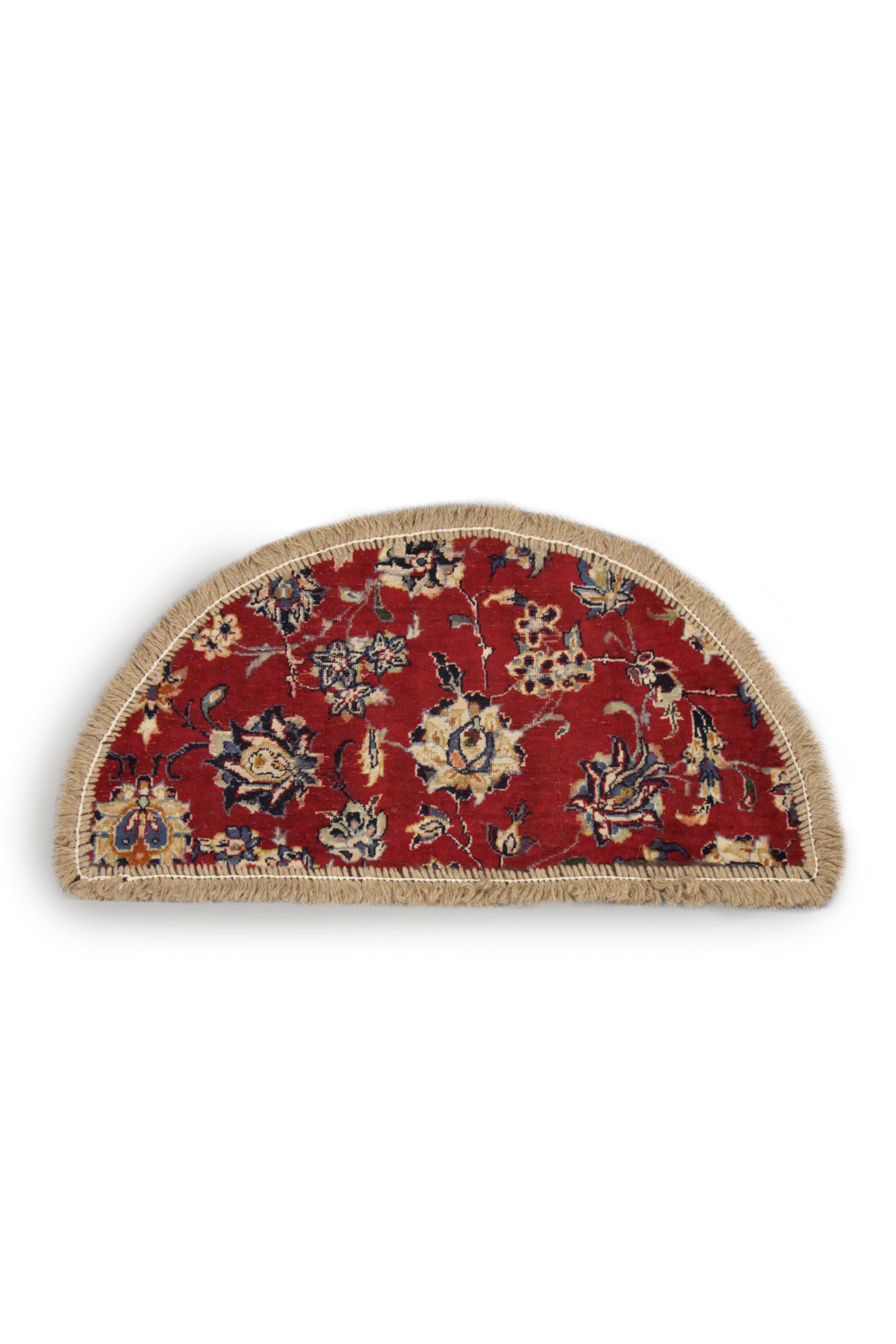 Handmade carpet delicate and detailed meandering floral motifs over this oriental rug floating on a background of deep red, perfect for use as a bedside rug or entranceway doormat. This semicircle entranceway doormat has been refurbished from a